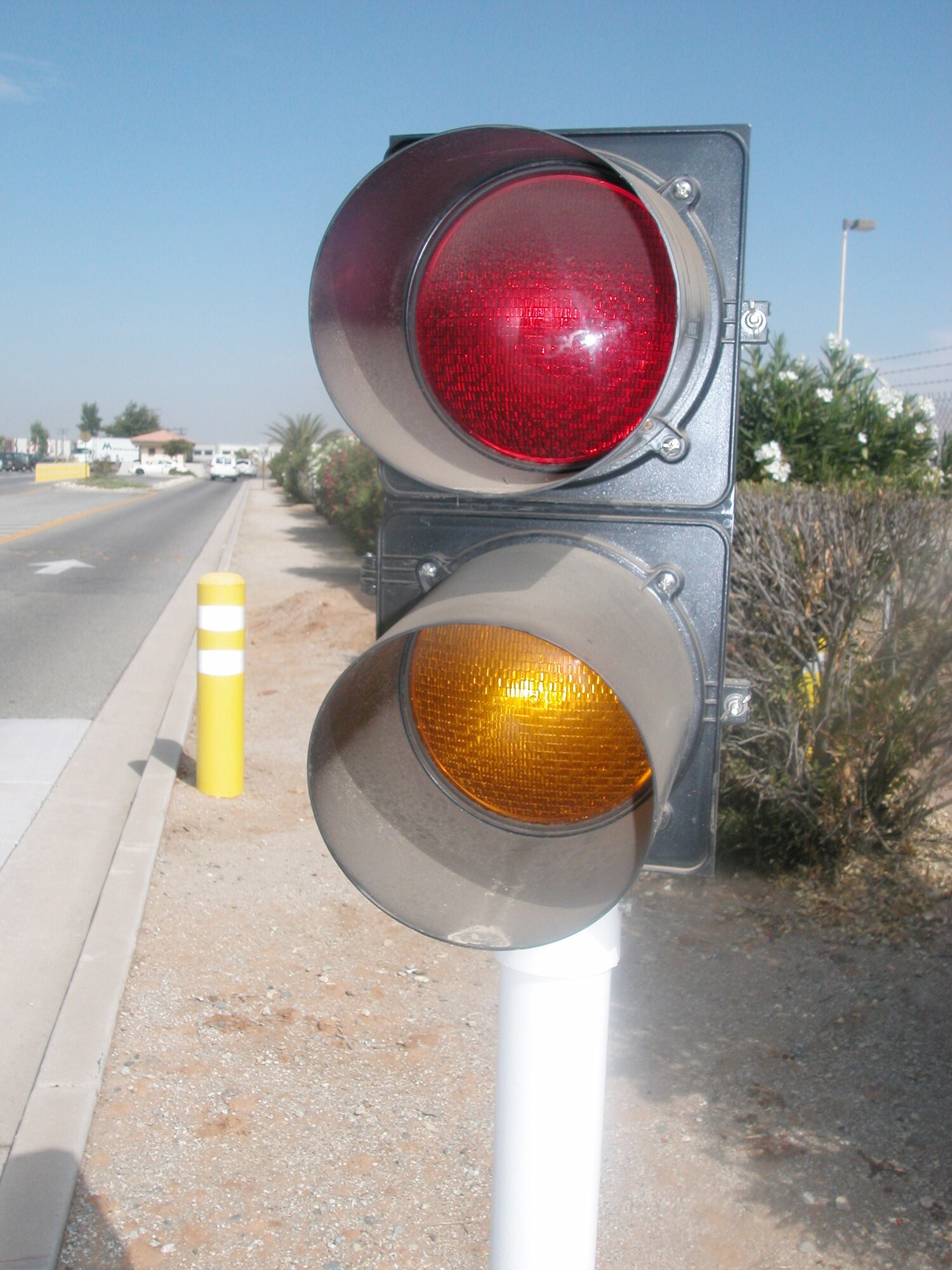 A light, similar to a traffic signal, warns drivers that the barriers are about to be raised. The moment the barriers are raised, the light switches from yellow to red.  (U.S. Air Force photo by Will Alexander, 452 AMW/PA)