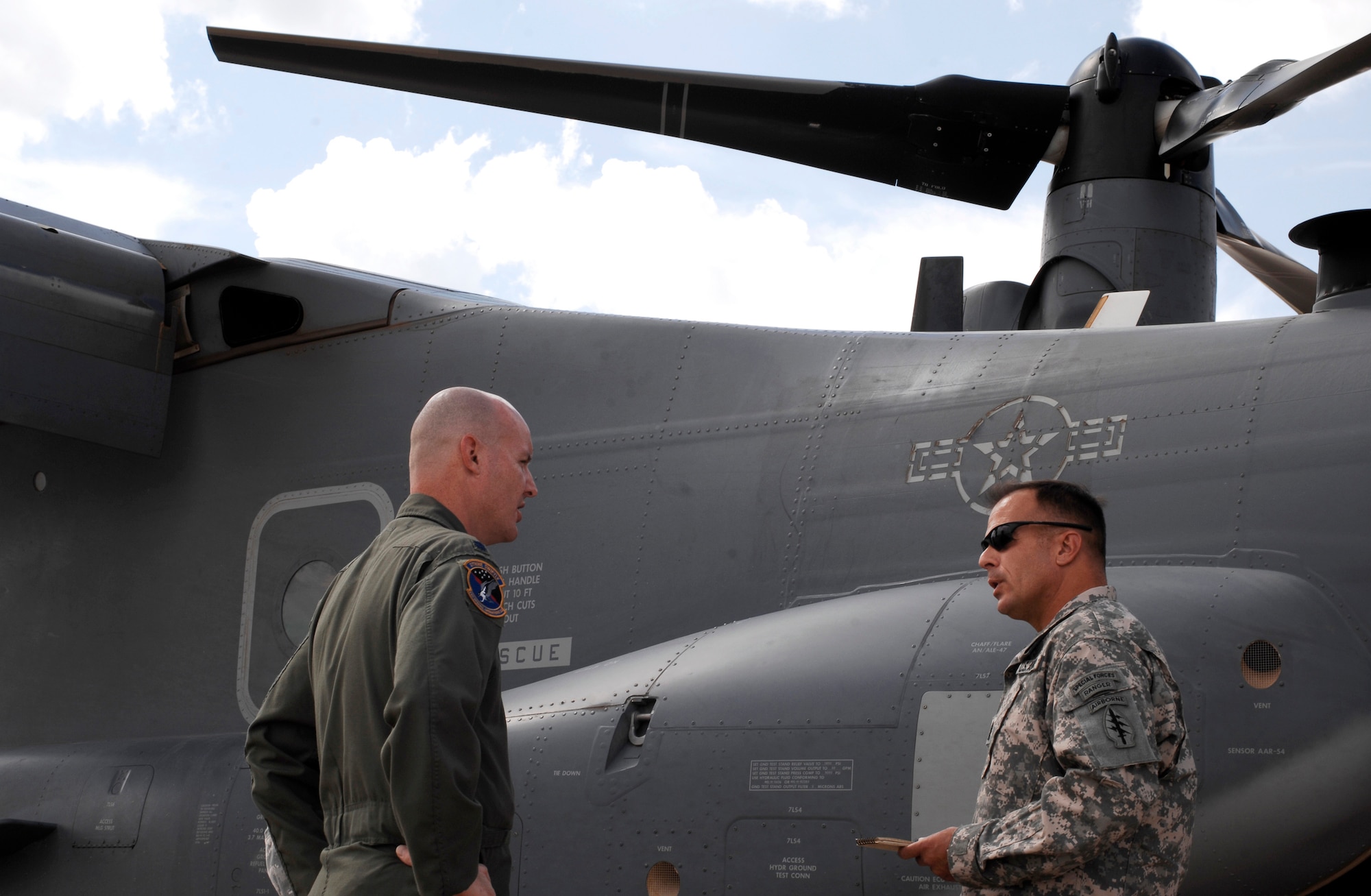CANNON AIR FORCE BASE, N.M. -- Lt. Col. Shawn Cameron, 71st Special Operations Squadron, speaks with Command Sgt. Major Frank Socha, U.S. Army Special Operations Command, about the capabilities of a CV-22 Osprey, during an aircraft static display, Sept. 10. The annual command sergeants' major conference was held here, from Sept. 7-12.  (U.S. Air Force photo/Senior Airman Liliana Moreno) (Released) 