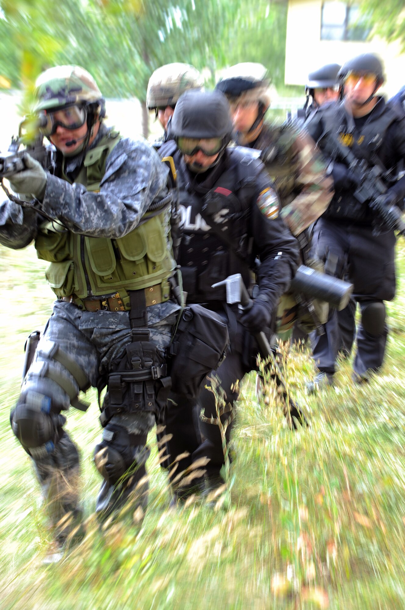 Dean Kippling, Mitchell Police Department police officer, leads a group around a house during a special weapons and tactics exercise on Sept. 12. SWAT teams are responsible for responding to and managing critical situations. (U.S. Air Force photo/Senior Airman Marc I. Lane)
