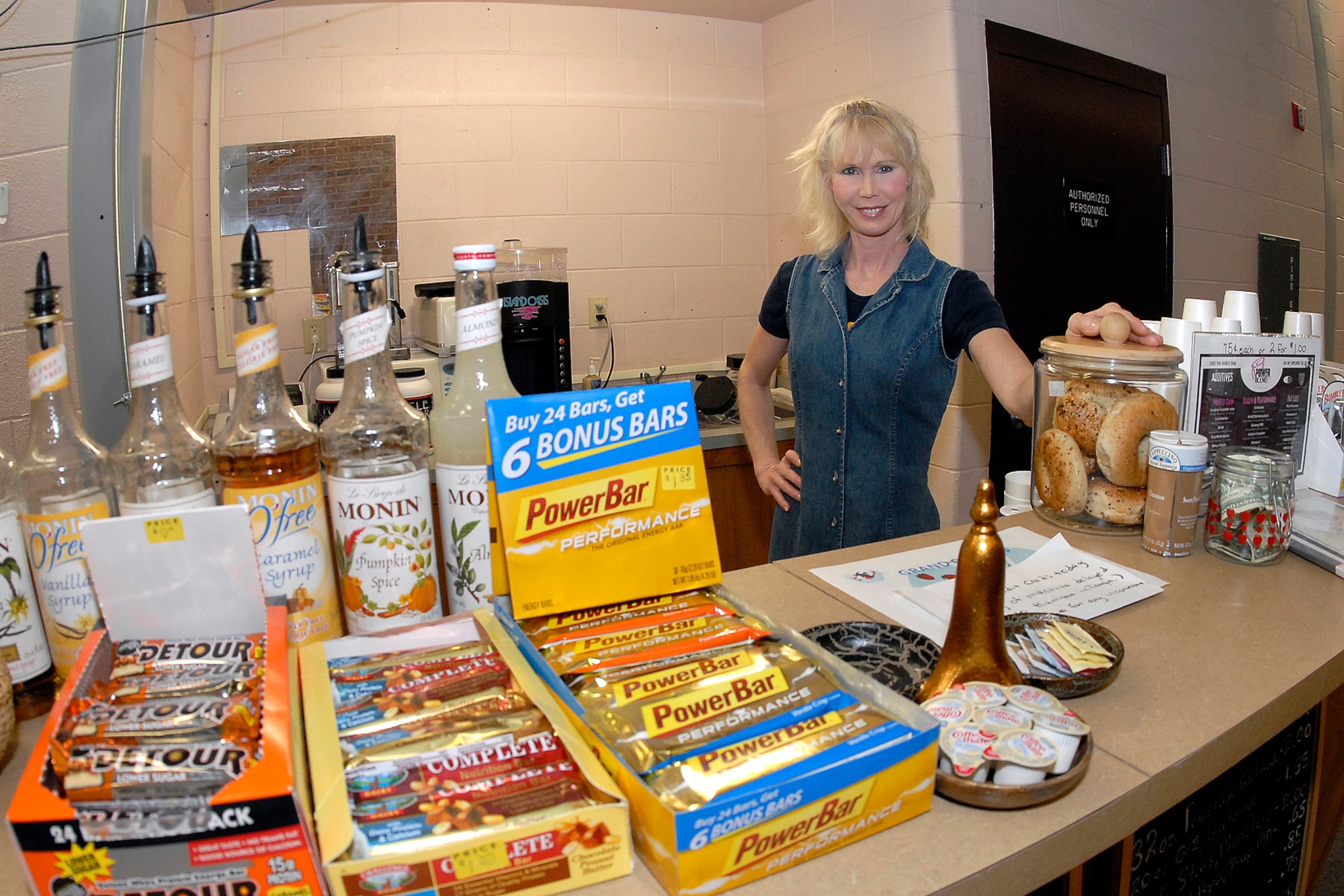 Ashleyann Carlson awaits her next customer Aug. 22 at the Peterson Fitness and Center. Mrs. Carlson recently opened the Wild Blue Yonder café, a health bar that offers a variety of nutritious snacks, as well as fruit smoothies, teas, coffees and espressos. Mrs. Carlson is the owner and operator of Wild Blue Yonder, which opened for business Aug. 21. (U.S. Air Force photo/Rob Bussard) 