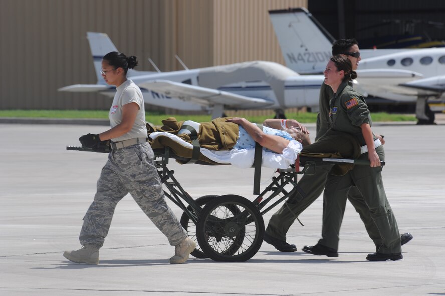 CORPUS CHRISTI, Texas- Medical personnel assist a patient back to the staging facility here, Sept. 11. The facility was set up two days ago to hold patients until C-130's arrive to transport them to safer locations in preparation of Hurricane Ike.  The Air Force and other military forces not only respond in support of war efforts abroad but also to threats on the home front including natural disasters. (U.S. Air Force photo/ Senior Airman Courtney Richardson) 