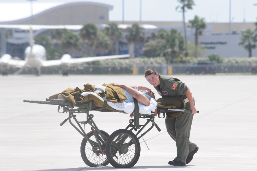 CORPUS CHRISTI, Texas- Staff Sergeant Athena Casango, Respiratory Therapist from Nellis Air Force Base, Nevada, listens to a patient while she takes him back to the staging facility here, Sept. 11. Sergeant Casango was part of the Critical Care Air Transport Team consisting of a doctor, a nurse and a respiratory therapist. The Air Force and other military forces not only respond in support of war efforts abroad but also to threats on the home front including natural disasters. (U.S. Air Force photo/ Senior Airman Courtney Richardson) 