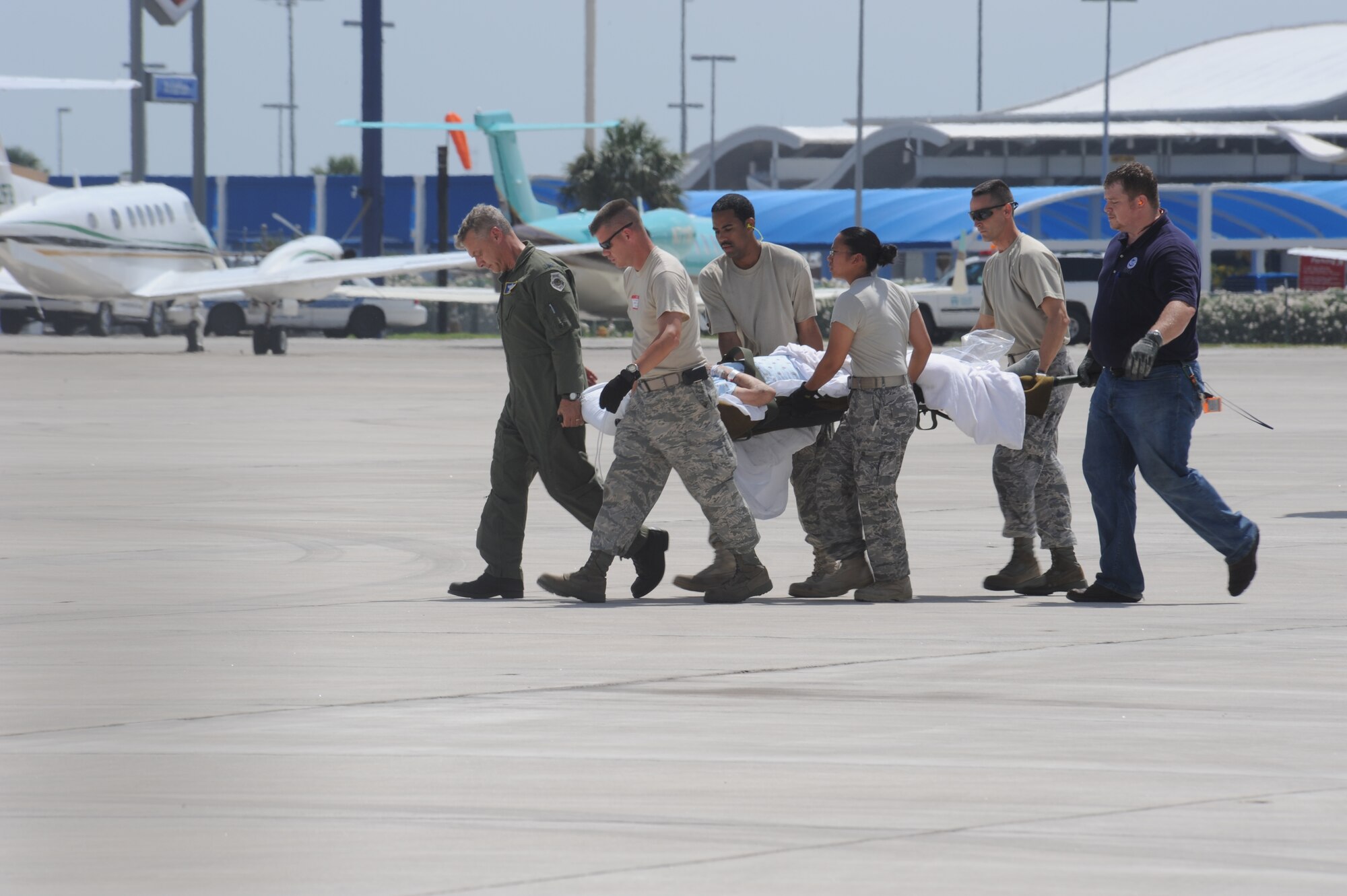 CORPUS CHRISTI, Texas-- Military medical personnel litter carry patients from C-130's to awaiting ambulances in here, Sept. 11. The medical assistance consisted of Air Force active duty, reserve and guard including the Army National Guard and civilian nurses. The Air Force and other military forces not only respond in support of war efforts abroad but also to threats on the home front including natural disasters. (U.S. Air Force photo/ Senior Airman Courtney Richardson) 