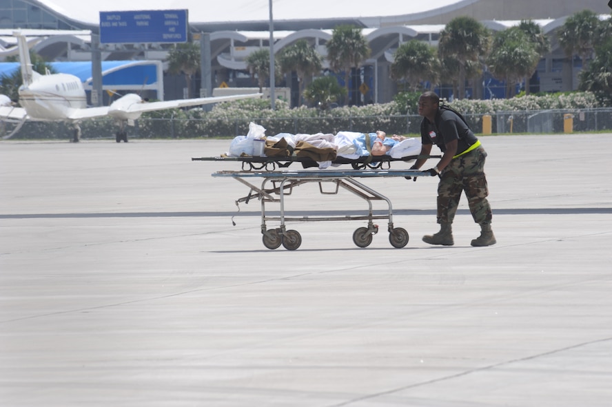 CORPUS CHRISTI, Texas- Senior Airman Kenneth Alexander, Areospace Medical Technician from McDill Air Force Base, Florida, pushes a gurney back to the staging facility from a C-130 here, Sept. 11. After learning that Hurricane Ike was shifting north, the patients from Corpus Christi were returned to the hospital and some of the C-130's were sent to Galveston, Texas to assist in the mandatory evacuation. The Air Force and other military forces not only respond in support of war efforts abroad but also to threats on the home front including natural disasters. (U.S. Air Force photo/ Senior Airman Courtney Richardson)