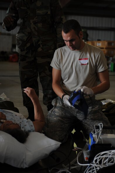 Corpus Christi, Texas- Staff Sergeant Clark Rutherford, Aerospace Medical Technician from McDill Air Force Base, Flordia, removes the blood pressure cuff from a patient at the staging facility here, Sept. 11. Patients' starting arriving around 11 p.m. Wednesday evening to wait for C-130's to take them to a safer location due to Hurricane Ike. The Air Force and other military forces not only respond in support of war efforts abroad but also to threats on the home front including natural disasters. (U.S. Air Force photo/ Senior Airman Courtney Richardson) 