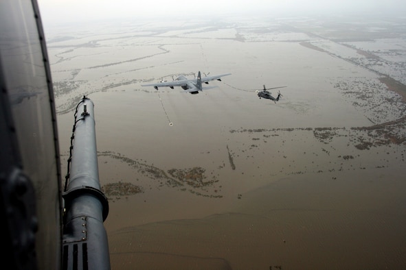 An HH-60 Pave Hawk helicopter from the Alaska Air National Guard's 176th Wing refuels over a flooded plain near Galveston, Texas on Sept. 12, 2008. The two Pave Hawks in the photo were deployed to the Gulf Coast region Sept. 1 to perform expected search-and-rescue missions in the wake of Hurricane Gustav. They remained on-station to aid rescue efforts relating to hurricanes Hannah and Ike (pictured). Alaska Air National Guard photo by TSgt. Sean Mitchell.