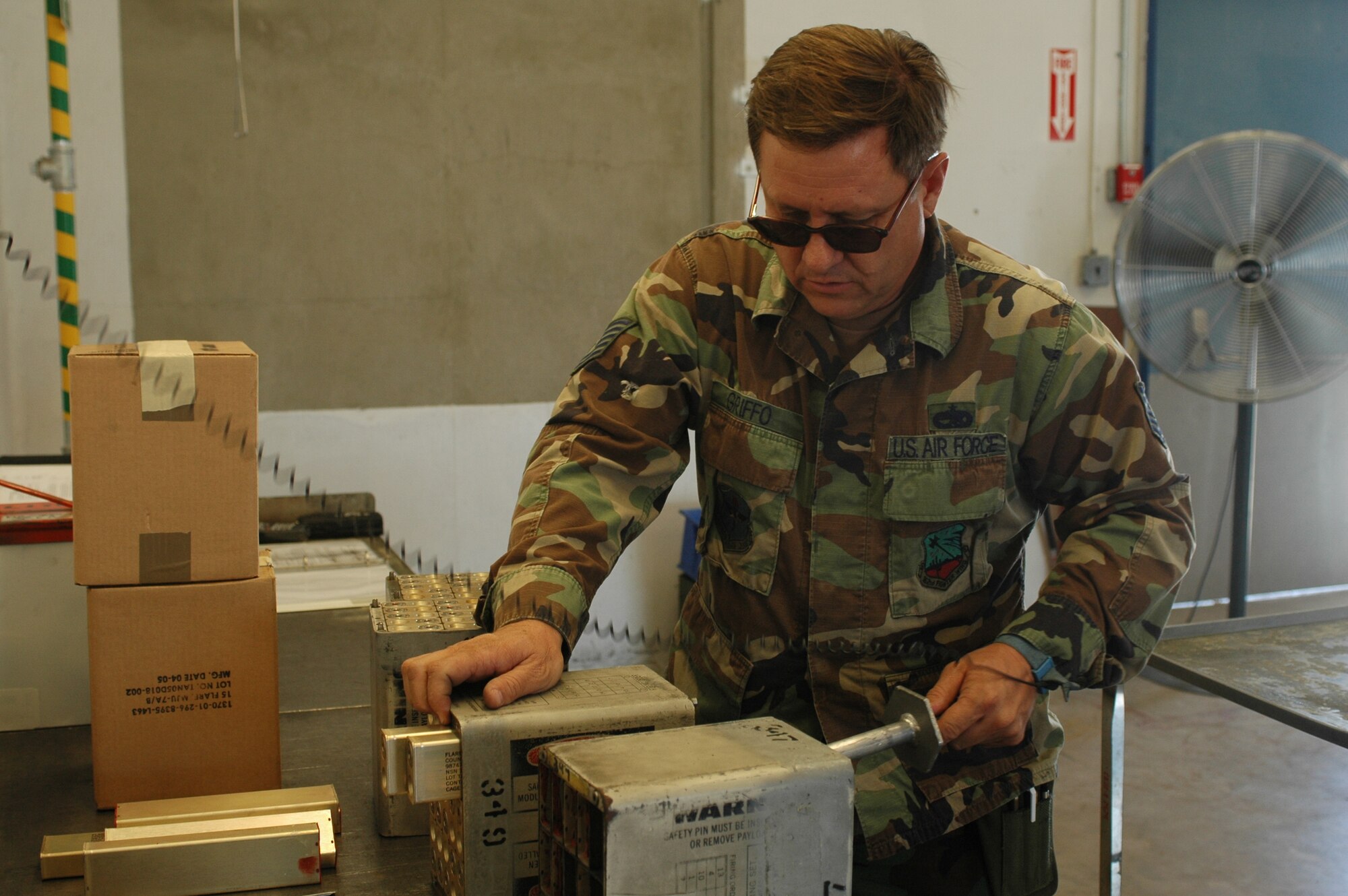 Tech. Sgt. Michael Griffo, munitions ordinance specialist, removes the expended flares from the MJU-7 case. These flares are used by the 148th Fighter Squadron during training exercises. Attached to Sergeant Griffo’s wrist is an electrical grounding strap used to prevent static electricity from building up and accidentally discharging the flare during servicing. (Air National Guard photo by Staff Sgt. Jordan Jones)
