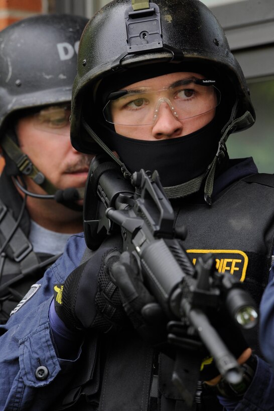 Brian Ritker, Codington County Sheriff’s Office deputy sheriff, provides cover as members of his team progress forward during special weapons and tactics training held here Sept. 12, 2008. SWAT is an elite special operations tactical unit trained to perform high-risk operations that fall outside of the abilities of regular patrol officers. (U.S. Air Force photo/Airman 1st Class Adam Grant)