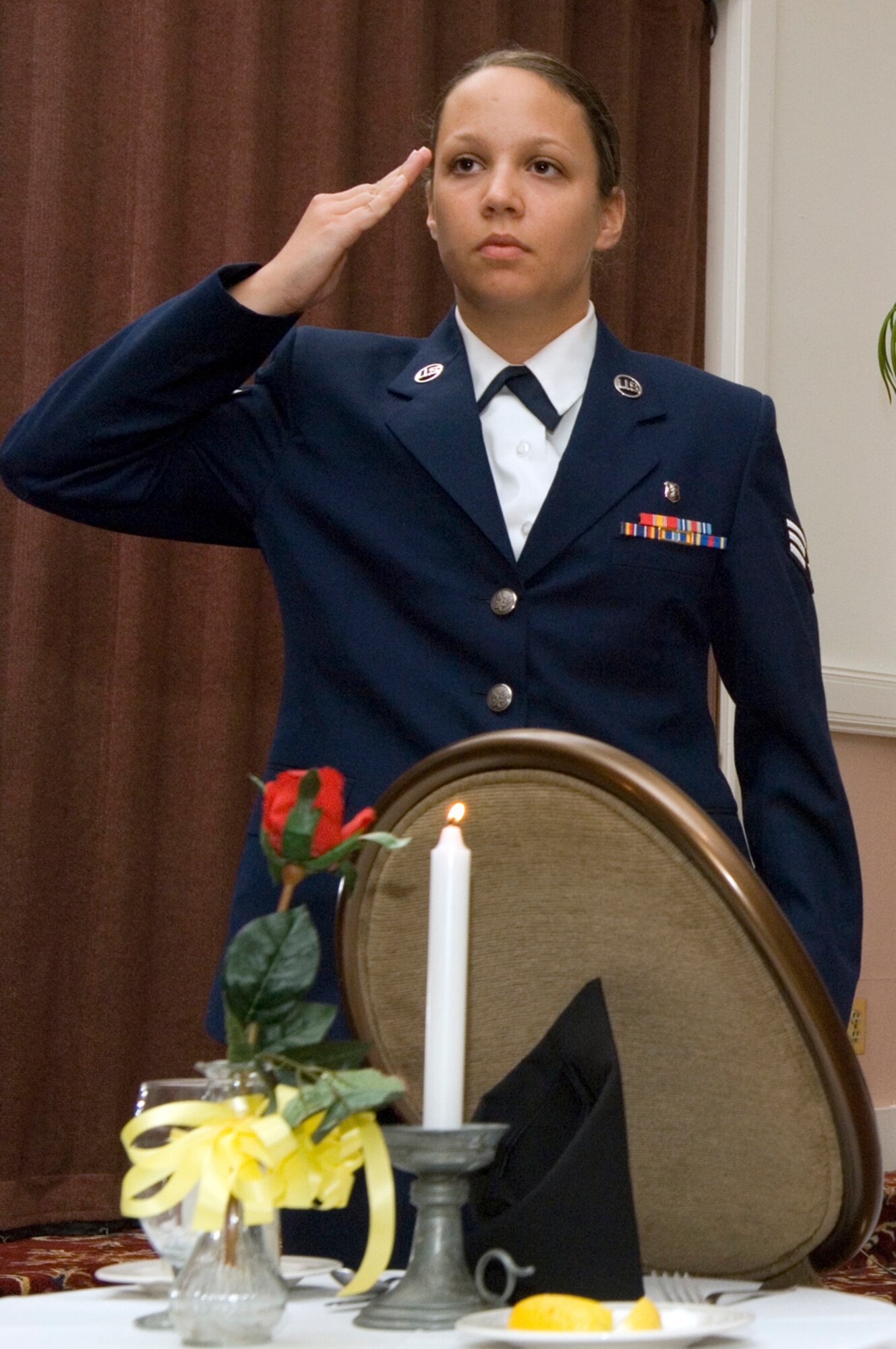 HANSCOM AFB, Mass. -- "They are unable to be with their loved ones and families tonight, so we join together to pay our humble tribute to them, and bear witness to their continued absence. Let us remember and never forget their sacrifices. May God forever watch over them and protect them and their families."
Senior Airman Amanda Carter, 66th Medical Operations Squadron dental technician, leads a ceremony honoring prisoners of war and servicemembers missing in action Sept. 4. Such ceremonies are held before many official base events to honor and remember fallen comrades. National POW/MIA Day is Sept. 19. The POW(U.S. Air Force photo by Mark Wyatt)
