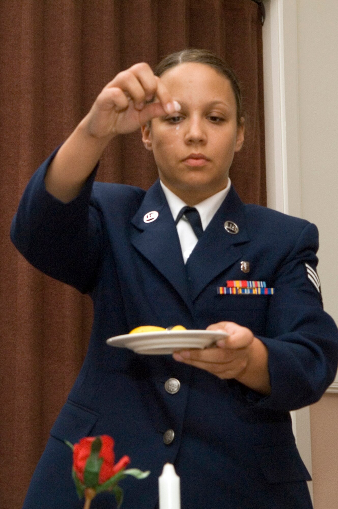 HANSCOM AFB, Mass. ? ?The salt sprinkled on the plate reminds us of the countless fallen tears of families as they wait.?
Senior Airman Amanda Carter, 66th Medical Operations Squadron dental technician, leads a ceremony honoring prisoners of war and servicemembers missing in action Sept. 4. Such ceremonies are held before many official base events to honor and remember fallen comrades. National POW/MIA Day is Sept. 19. (U.S. Air Force photo by Mark Wyatt)
