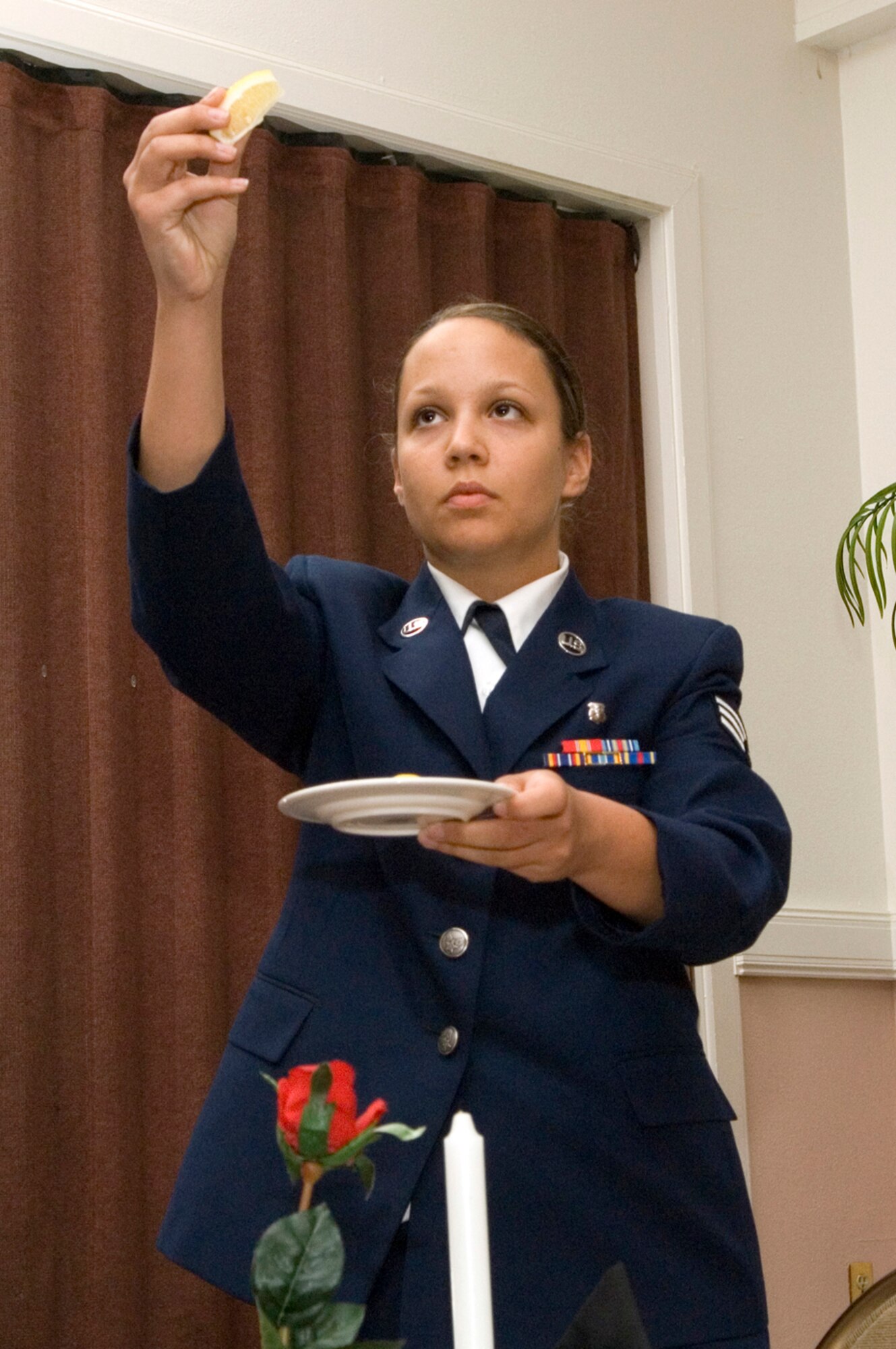 HANSCOM AFB, Mass. -- "A slice of lemon on the plate reminds us of their bitter fate."
Senior Airman Amanda Carter, 66th Medical Operations Squadron dental technician, leads a ceremony honoring prisoners of war and servicemembers missing in action Sept. 4. Such ceremonies are held before many official base events to honor and remember fallen comrades. National POW/MIA Day is Sept. 19. (U.S. Air Force photo by Mark Wyatt)
