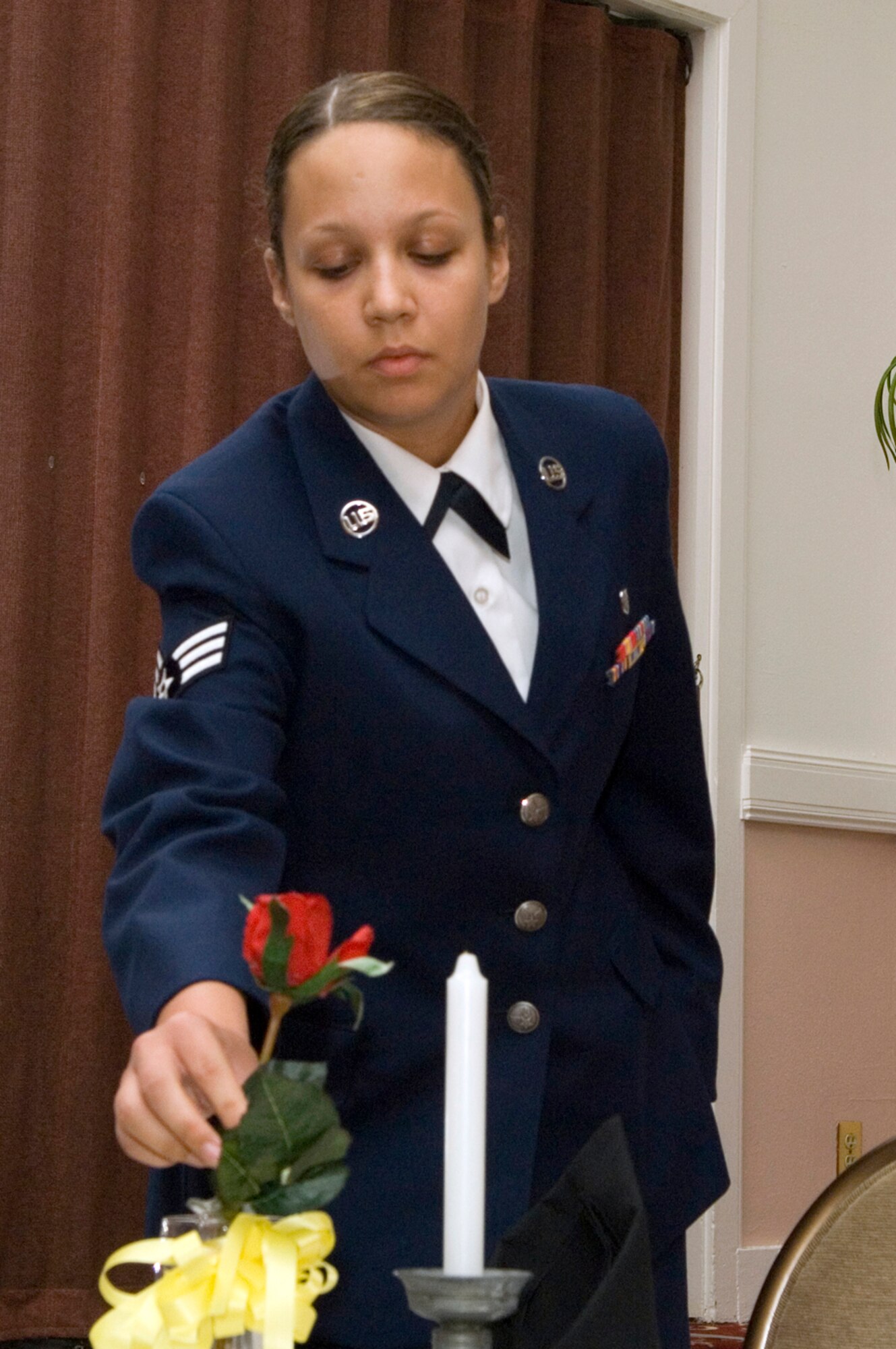 HANSCOM AFB, Mass. -- "This table, set for one, is small, symbolizing the frailty of one prisoner, alone against his or her suppressors. The single red rose in the vase, signifies the blood they many have shed in sacrifice to ensure the freedom of our beloved United States of America. This rose also reminds us of the family and friends of our missing comrades who keep the faith, while awaiting their return."
Senior Airman Amanda Carter, 66th Medical Operations Squadron dental technician, leads a ceremony honoring prisoners of war and servicemembers missing in action Sept. 4. Such ceremonies are held before many official base events to honor and remember fallen comrades. National POW/MIA Day is Sept. 19. (U.S. Air Force photo by Mark Wyatt)
