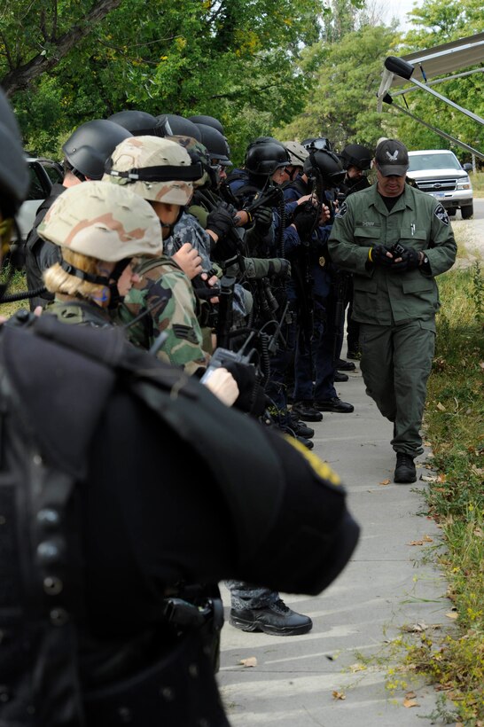 Members of various police departments await the issue of radio communications at   special weapons and tactics training held here Sept. 12, 2008. SWAT is an elite special operations tactical unit, trained to perform high-risk operations that fall outside the abilities of regular patrol officers. (U.S. Air Force photo/Airman 1st Class Adam Grant)
