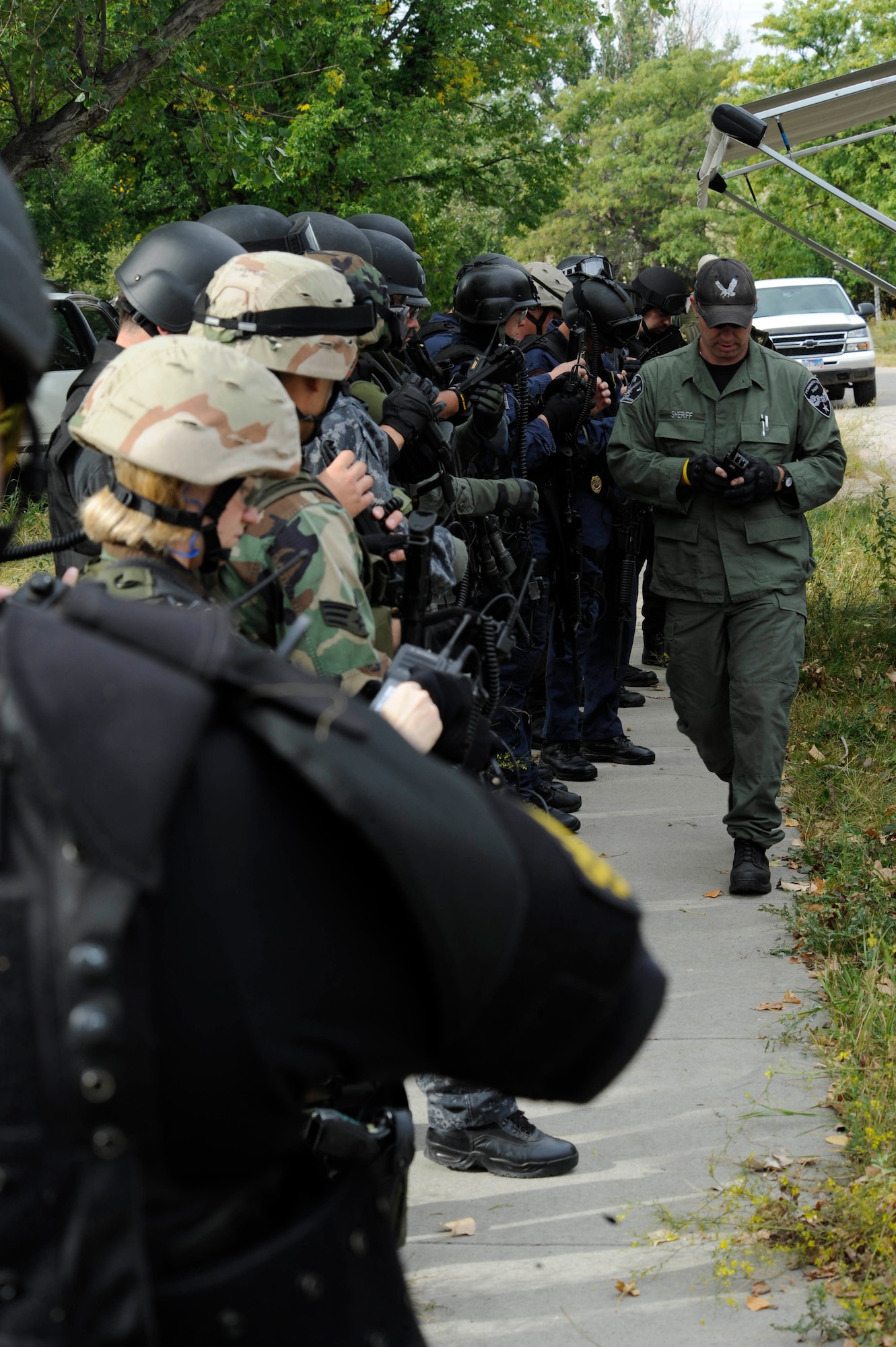 Members of various police departments await the issue of radio communications at   special weapons and tactics training held here Sept. 12, 2008. SWAT is an elite special operations tactical unit, trained to perform high-risk operations that fall outside the abilities of regular patrol officers. (U.S. Air Force photo/Airman 1st Class Adam Grant)