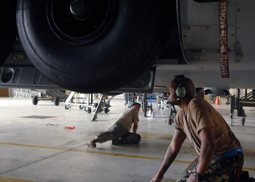 MOODY AIR FORCE BASE, Ga. -- Staff Sgt. Michael Scales and Staff Sgt. Benjamin Aldridge, 23rd Equipment Maintenance Squadron aero repair isochronal craftsmen, perform an operation check for the main landing gear of a HC-130P Hercules here Sept. 5. Isochronal means their work is done on a timed schedule. (U.S. Air Force photo by Airman Joshua Green) 