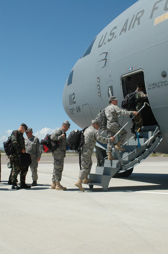 Air National Guardsmen heading to Balad Air Base, Iraq, board a C-17 from the 172nd Airlift Wing at Tucson International Airport. Over the next few months the 162nd Fighter Wing will send several rotations of maintainers to support Guard F-16s operating in Iraq. (Air National Guard photo by Capt. Gabe Johnson)