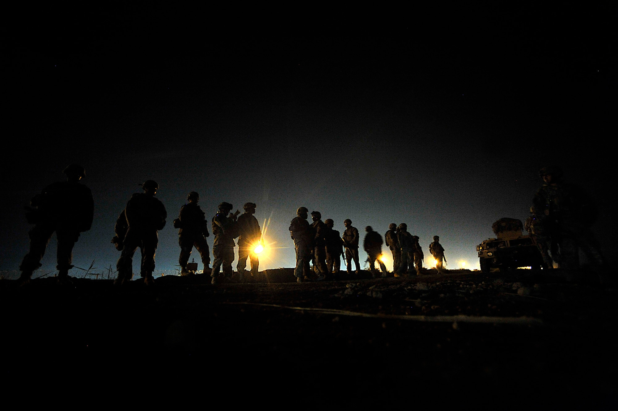 Airmen and Soldiers prepare for Operation Lewis and Clark Sept. 11 at Joint Base Balad, Iraq.  Operation Lewis and Clark was a joint patrol in which Air Force security forces Airmen were introduced to Balad's outer perimeter, an area in which they will assume responsibility from the Army. (U.S. Air Force photo by Staff Sgt. Aaron Allmon) 
