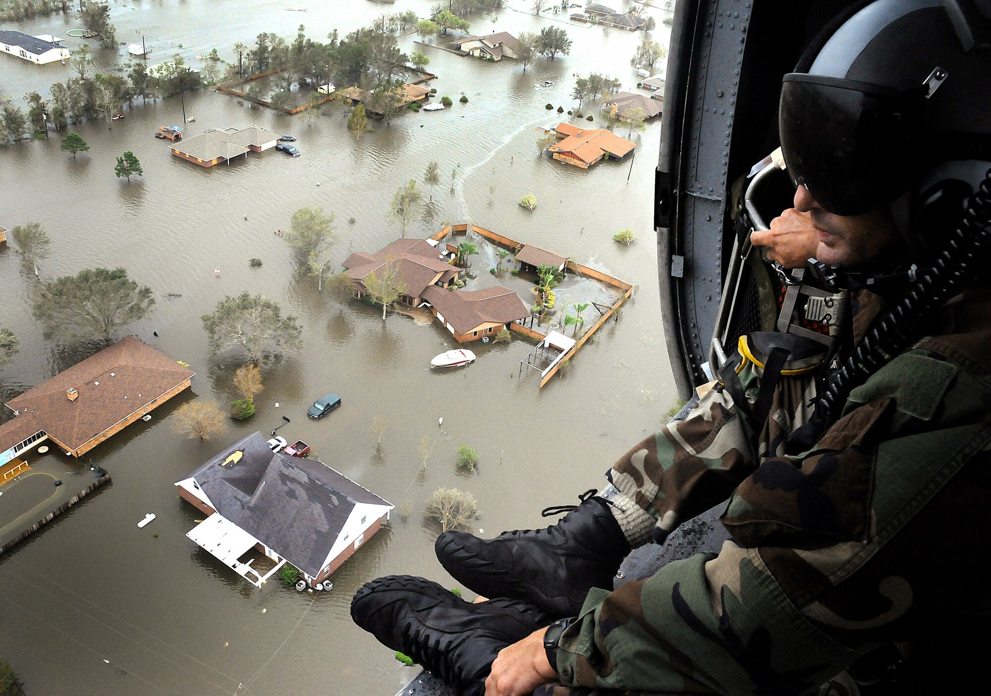 An Air Force Reserve pararescueman assigned to the 331st Air Expeditionary Group scans the ravaged Texas landscape for signs of life in the aftermath of Hurricane Ike. Deployed from the 920th Rescue Wing at Patrick Air Force Base, Fla., the pararescuemen, along with aircrews, two HH-60G Pave Hawk helicopters and two HC-130P/N refueling aircraft, rescued 17 people from the small Texas town of Nederland Sept. 13. (U.S. Air Force photo/Tech. Sgt. Paul Flipse)