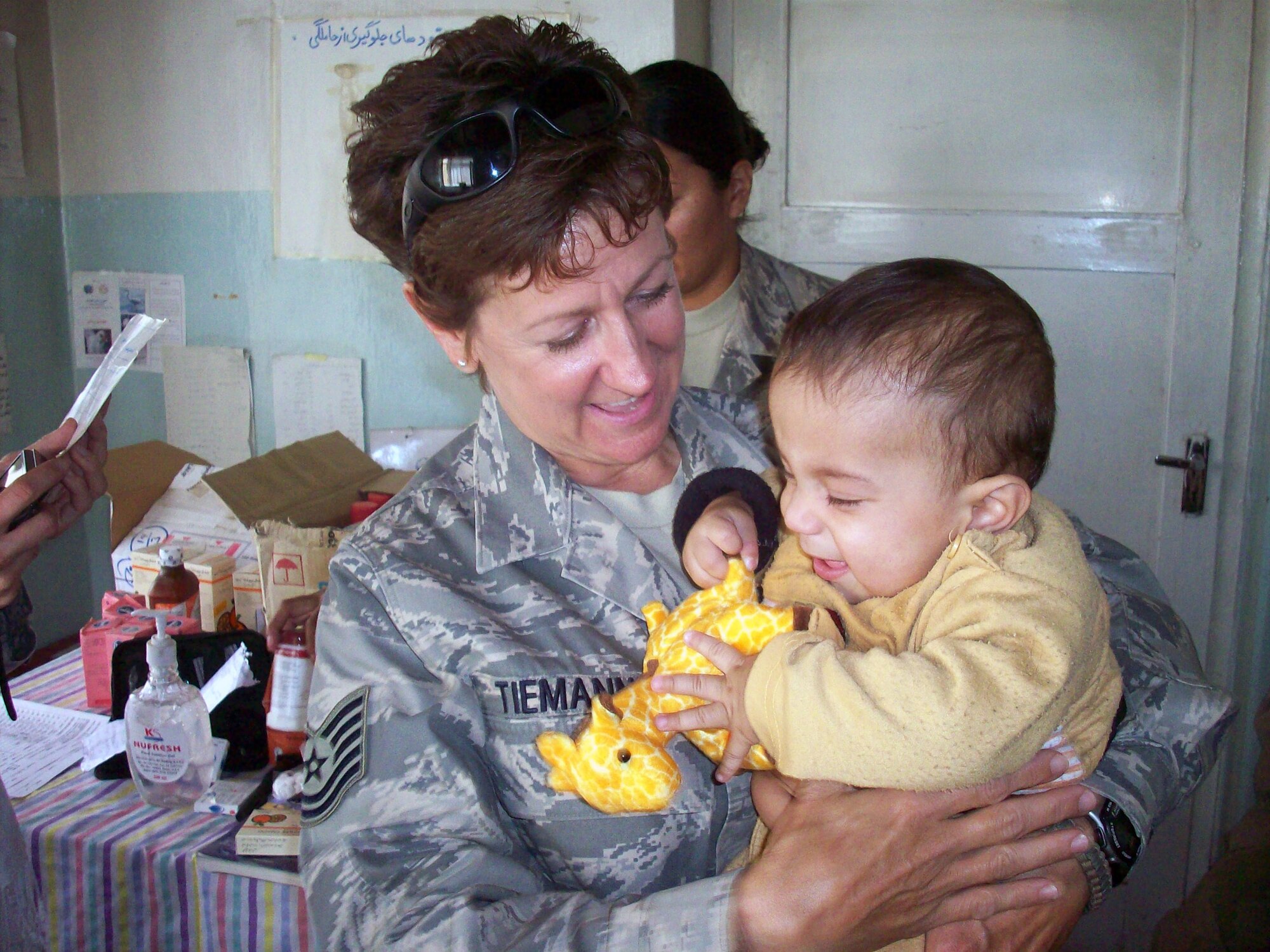 Tech. Sgt. Dawn Tiemann holds a baby during a medical engagement in Panjshir province. Doctors in Panjshir treated 473 Afghan patients in two districts, Rohka and Shutol, with the Panjshir PRT medical team assisting. Sergeant Tiemann is a Panjshir Provincial Reconstruction Team medical technician. (U.S. Army photo/1st Lt. Lory Stevens)