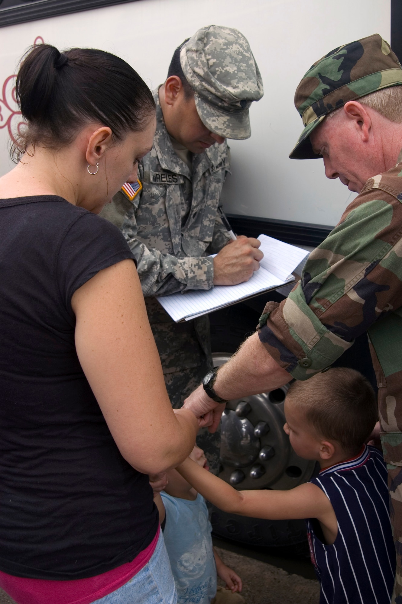 Capt. Bill Gentry took identification information from evacuees and handed out water as approximately 1,000 people boarded buses bound for San Antonio Sept. 14 at Galveston, Texas. Captain Gentry is from the 149th Medical Group, Texas Air National Guard. (U.S. Air Force photo/Tech. Sgt. Matthew McGovern) 
