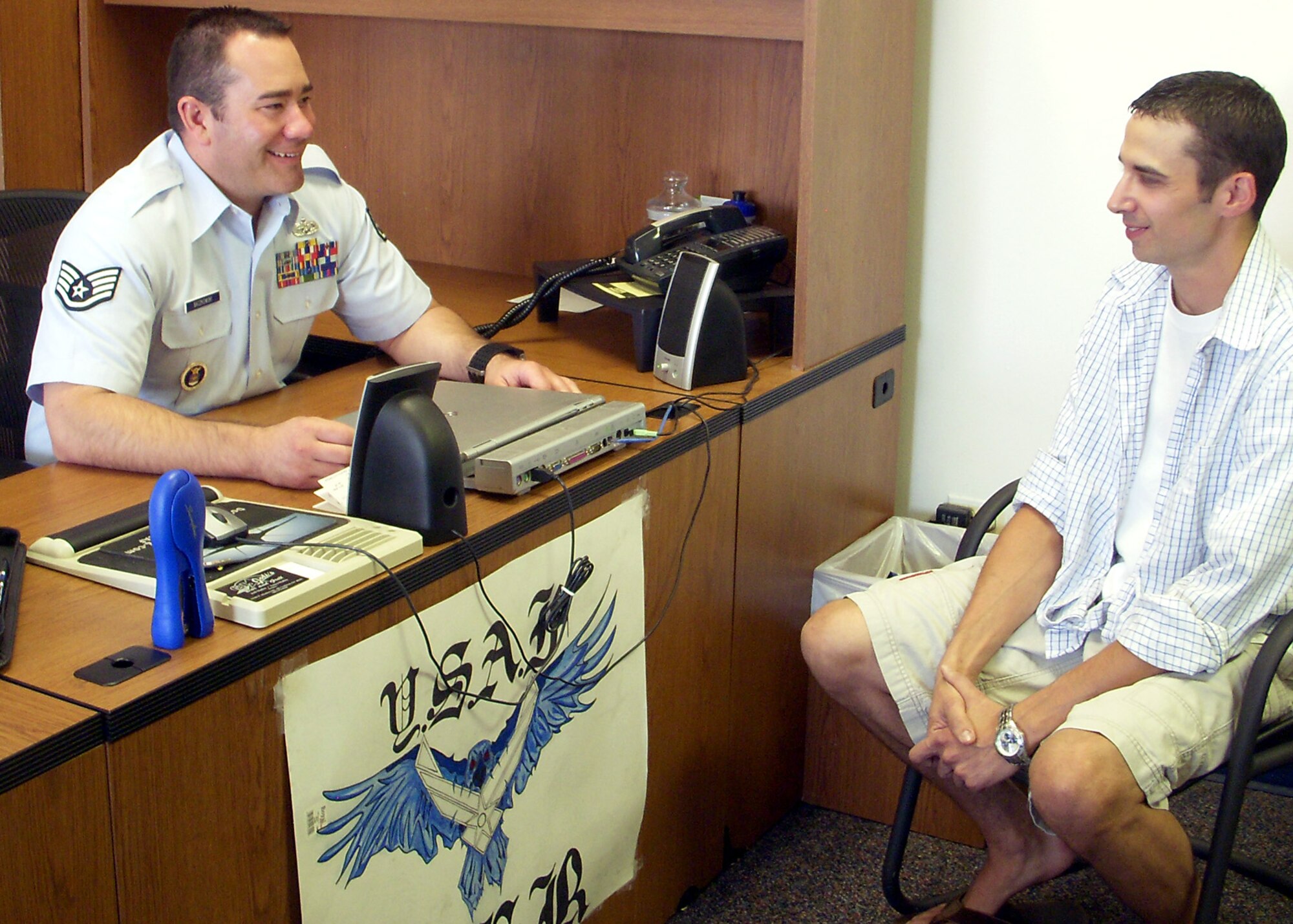 Staff Sgt. Corey Baczkowski speaks with a potential Air Force recruit in his office in Littleton, Colo. The 367th Recruiting Squadron NCO donated bone marrow through the C.W. Bill Young Department of Defense Marrow Donor Program in August to help save the life of a man who suffers from advanced lymphoma. (U.S. Air Force photo/Master Sgt. Carrie Rios)