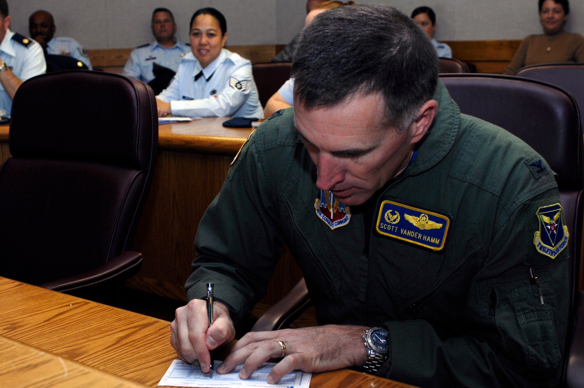 Col. Scott Vander Hamm, 28th Bomb Wing commander, makes the donation which kicksoff Ellsworth's 2008 Combined Federal Campaign here Sept. 15.  The base's goal for 2008 is $105,000, a goal $15,000 higher than last year's. The campaign will run until Oct. 8, while unit points-of-contact establish 100 percent face-to-face contact with potential contributors across the base to achieve the monetary goal. (U.S. Air Force photo/Airman Matthew Flynn)