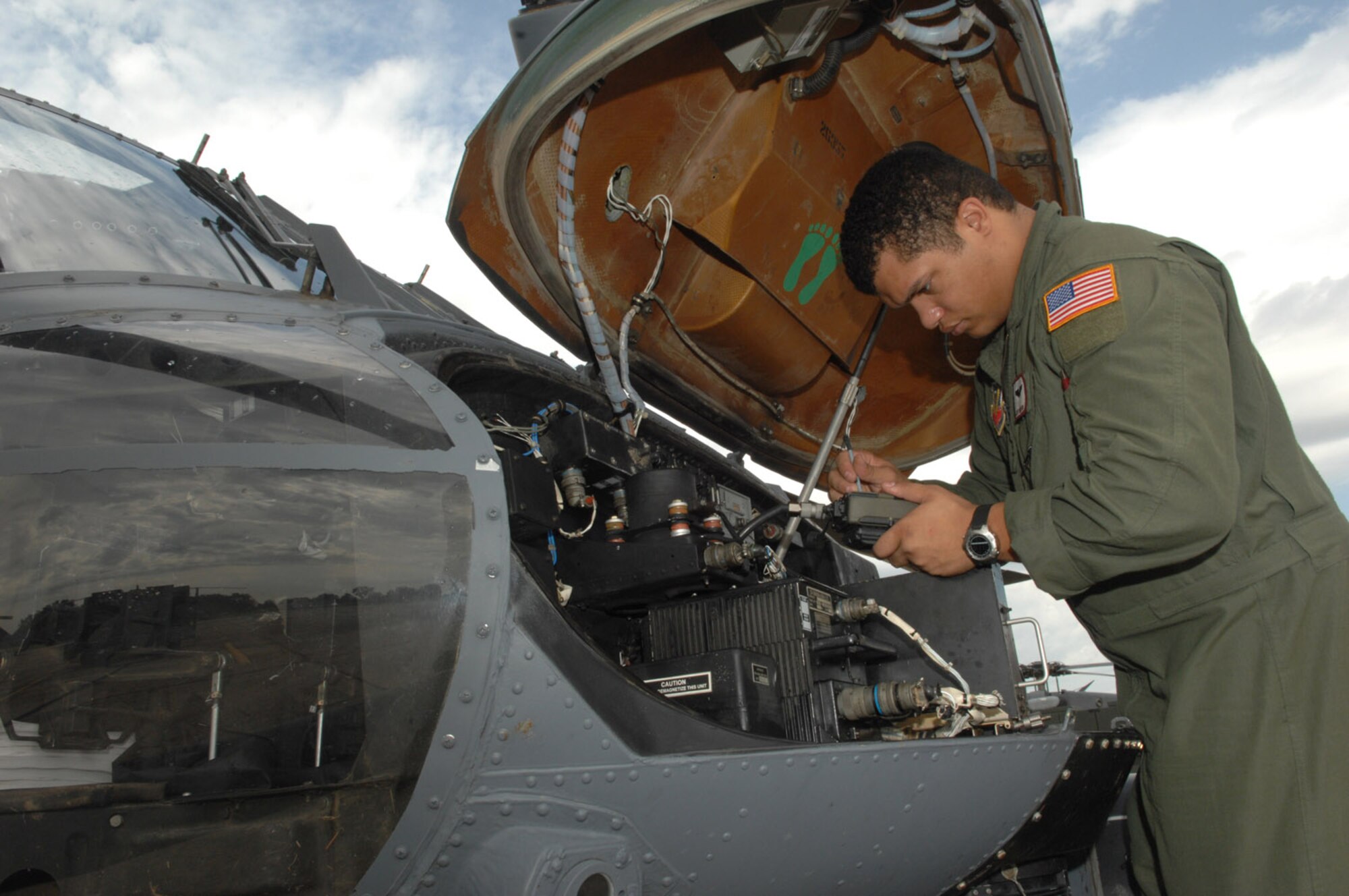 RANDOLPH AIR FORCE BASE, Texas -- Senior Airman Josh Martin, an aerial gunner assigned to the 563rd Rescue Squadron from Davis-Monthan Air Force Base, Ariz., loads radios during a pre-flight inspection on an HH-60G on the flight line of Randolph Air Force Base, Texas.  Airman Martin, along with more than 100 other Airmen from D-M, deployed to Randolph to support search and rescue missions for victims of Hurricane Ike.  (U.S. Air Force photo by Senior Airman Alesia D. Goosic)