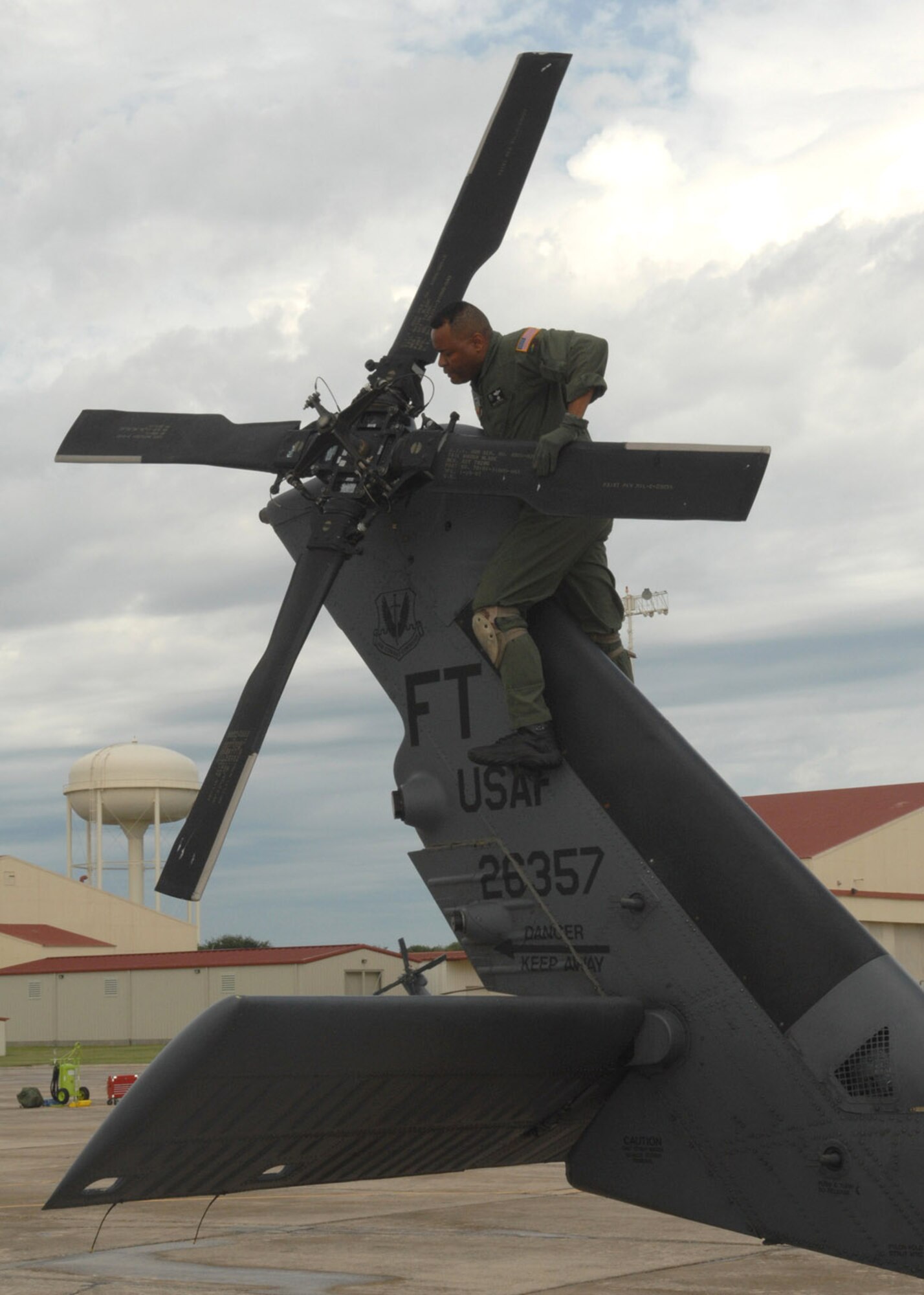 RANDOLPH AIR FORCE BASE, Texas -- Chief Master Sgt. Kenneth Price, a flight engineer from the 563rd Rescue Squadron from Davis-Monthan, performs a pre-flight inspection on an HH-60G Pave Hawk on the flight line of Randolph Air Force Base, Texas.  D-M deployed five HH-60s and more than 100 personnel to Randolph in support of search and rescue missions for victims of Hurricane Ike.  (U.S. Air Force photo by Senior Airman Alesia D. Goosic) 