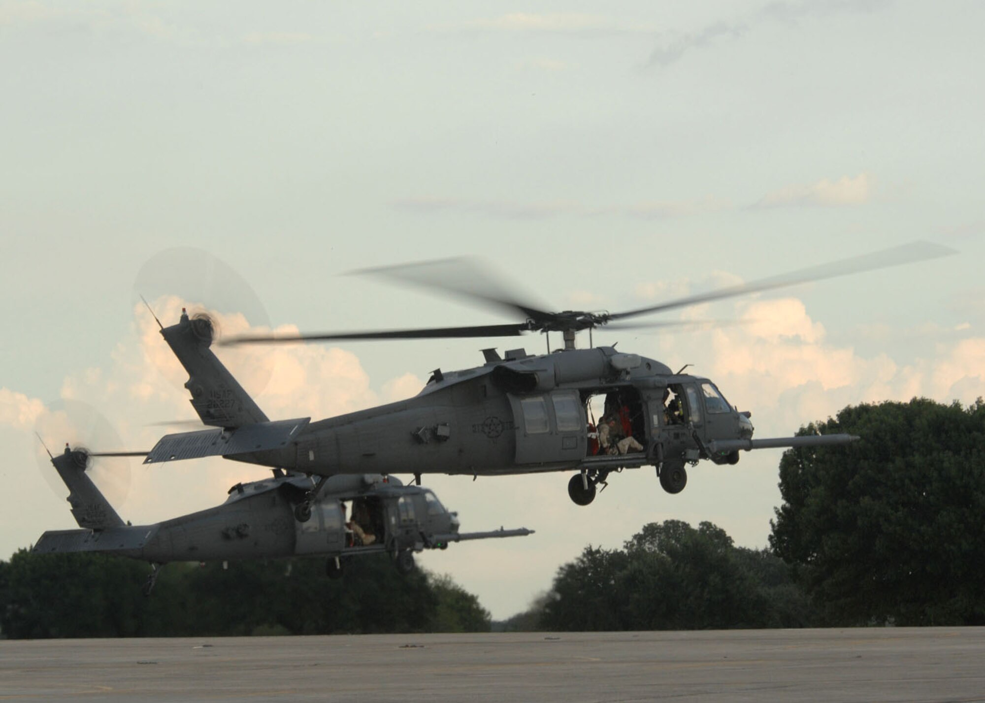 RANDOLPH AIR FORCE BASE, Texas -- Two HH-60G Pave Hawks from Davis-Monthan take off from the flight line at Randolph Air Force Base, Texas Sept. 13 to perform search and rescue missions for victims of Hurricane Ike. D-M provided five HH-60s and more than 100 personnel for this mission. (U.S. Air Force photo by Senior Airman Alesia D. Goosic)