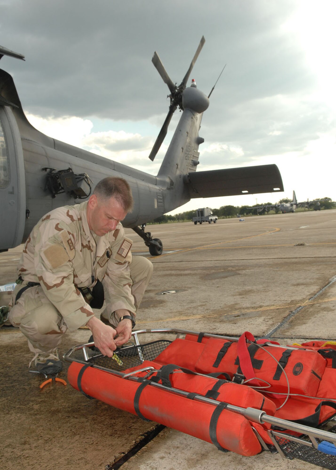 RANDOLPH AIR FORCE BASE, Texas -- Senior Master Sgt. David Swan, a member of the 48th Rescue Squadron stationed at Davis-Monthan Air Force Base, Ariz., preps a litter before loading it onto a HH-60 Pavehawk on the Randolph Air Force Base flight line before leaving for a search and rescue mission to help victims of Hurricane Ike Sept. 13.  (U.S. Air Force photo by Senior Airman Alesia D. Goosic)
