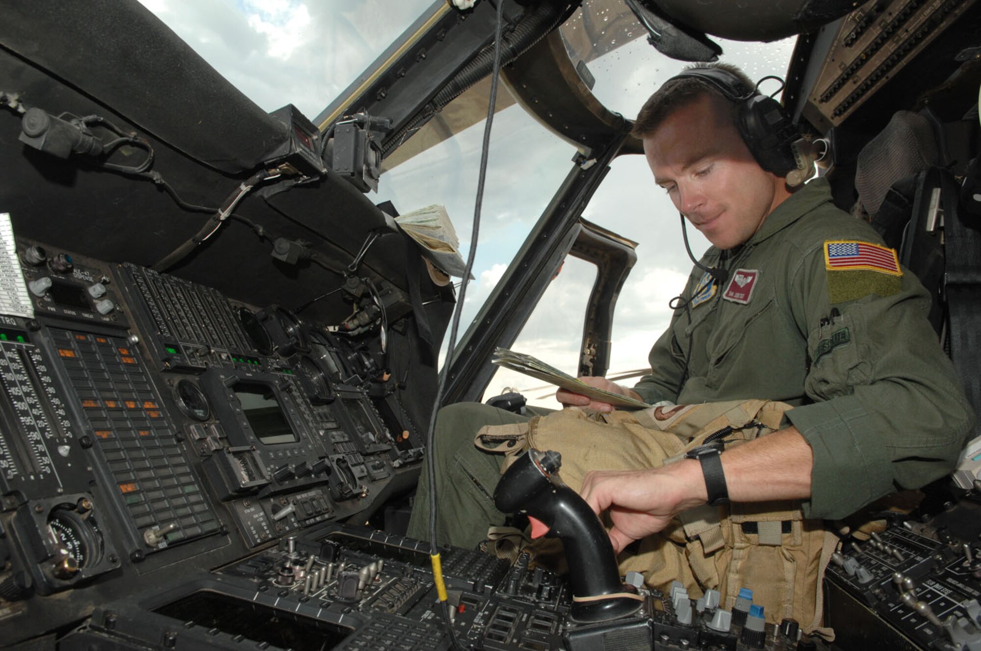 RANDOLPH AIR FORCE BASE, Texas -- Tech. Sgt. Dan Juen programs radio frequencies into the flight deck of an HH-60G Pave Hawk on the flight line of Randolph Air Force Base, Texas Sept. 13. Sergeant Juen is a flight engineer with the 305th Rescue Squadron at Davis-Monthan and was preparing the HH-60 for a search and rescue mission for victims of Hurricane Ike. (U.S. Air Force photo by Senior Airman Alesia D. Goosic)