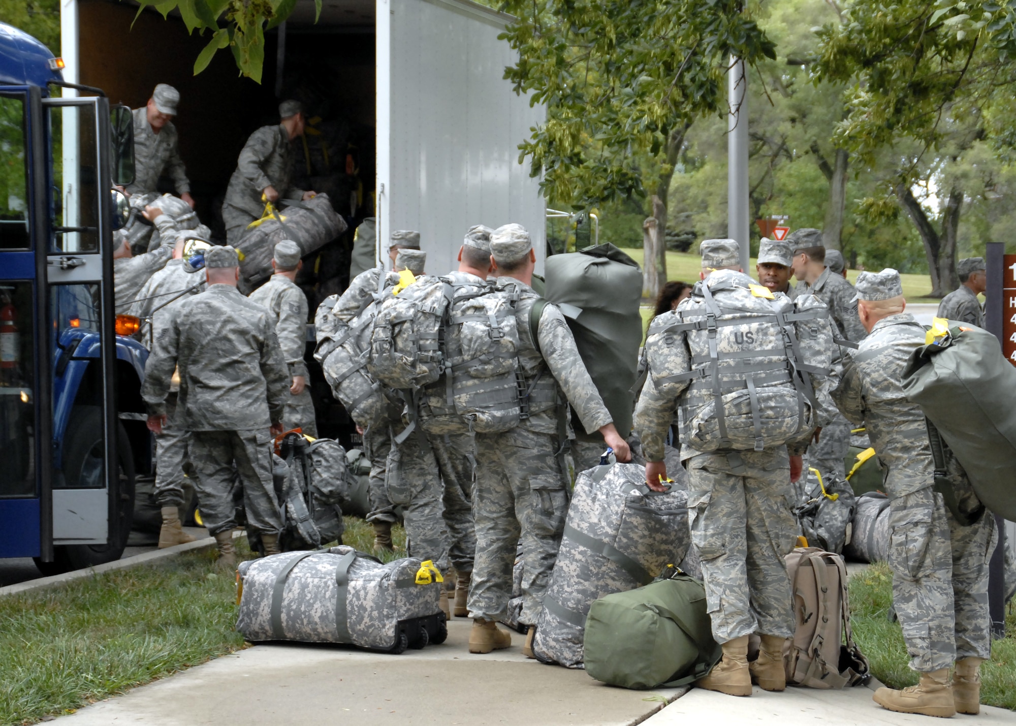 WRIGHT-PATTERSON AFB, Ohio - Airmen of the 445th Civil Engineer Squadron load deployment bags and equipment onto trucks before departing for a six-month deployment to Southwest Asia on Tuesday, September 9, 2008. The team from the 445th Airlift Wing is deploying “in lieu of” which places the Airmen under the direction of the U.S. Army for the next six months providing construction support. (U.S. Air Force photo/Tech. Sgt. Charlie Miller)