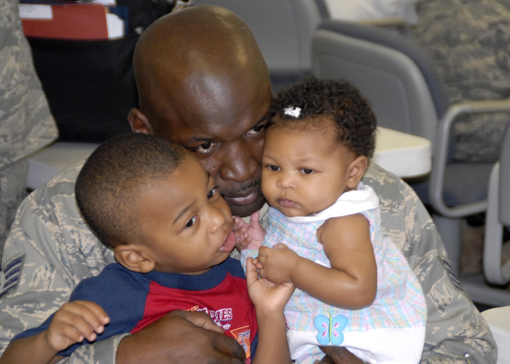 WRIGHT-PATTERSON AFB, Ohio - Staff Sgt. Irvan Higgins, 445th Civil Engineer Squadron utilities apprentice, holds his son Je-lyn and daughter Jadea before leaving for a six month deployment to Southwest Asia  on Tuesday, September 9, 2008. Sergeant Higgins is part of a sixty member team from the 445th Airlift Wing that will be deployed to Southwest Asia for the next six months providing construction support. (U.S. Air Force photo/Tech. Sgt. Charlie Miller)