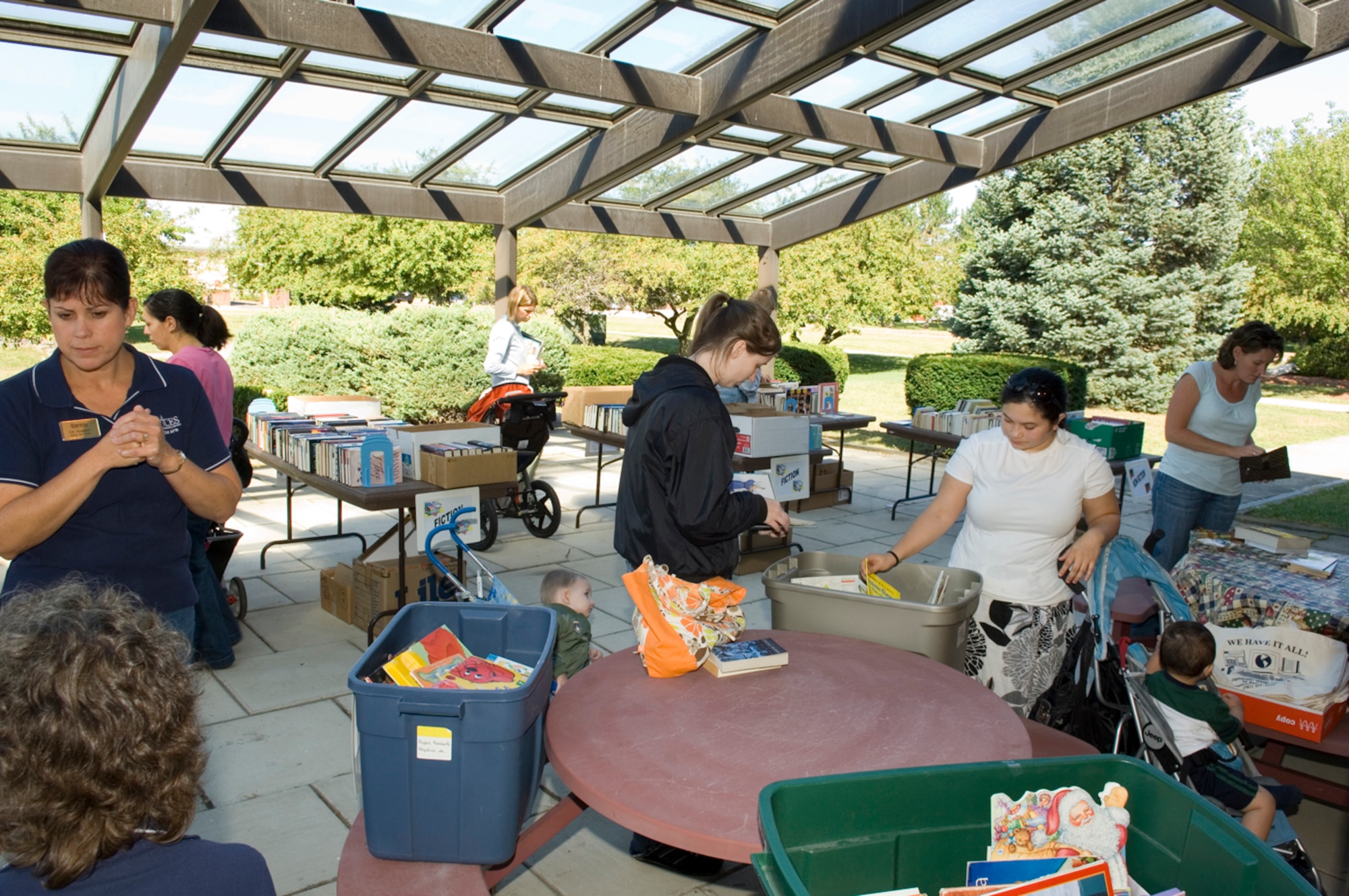 HANSCOM AFB, Mass. -- Library patrons peruse the used book sale held on the library's patio Sept. 11. In addition to all genres of books, the library has a number of reduced admission passes to area museums and attractions available to base families. For more information, visit www.hanscomservices.com. (U.S. Air Force photo by Rick Berry)