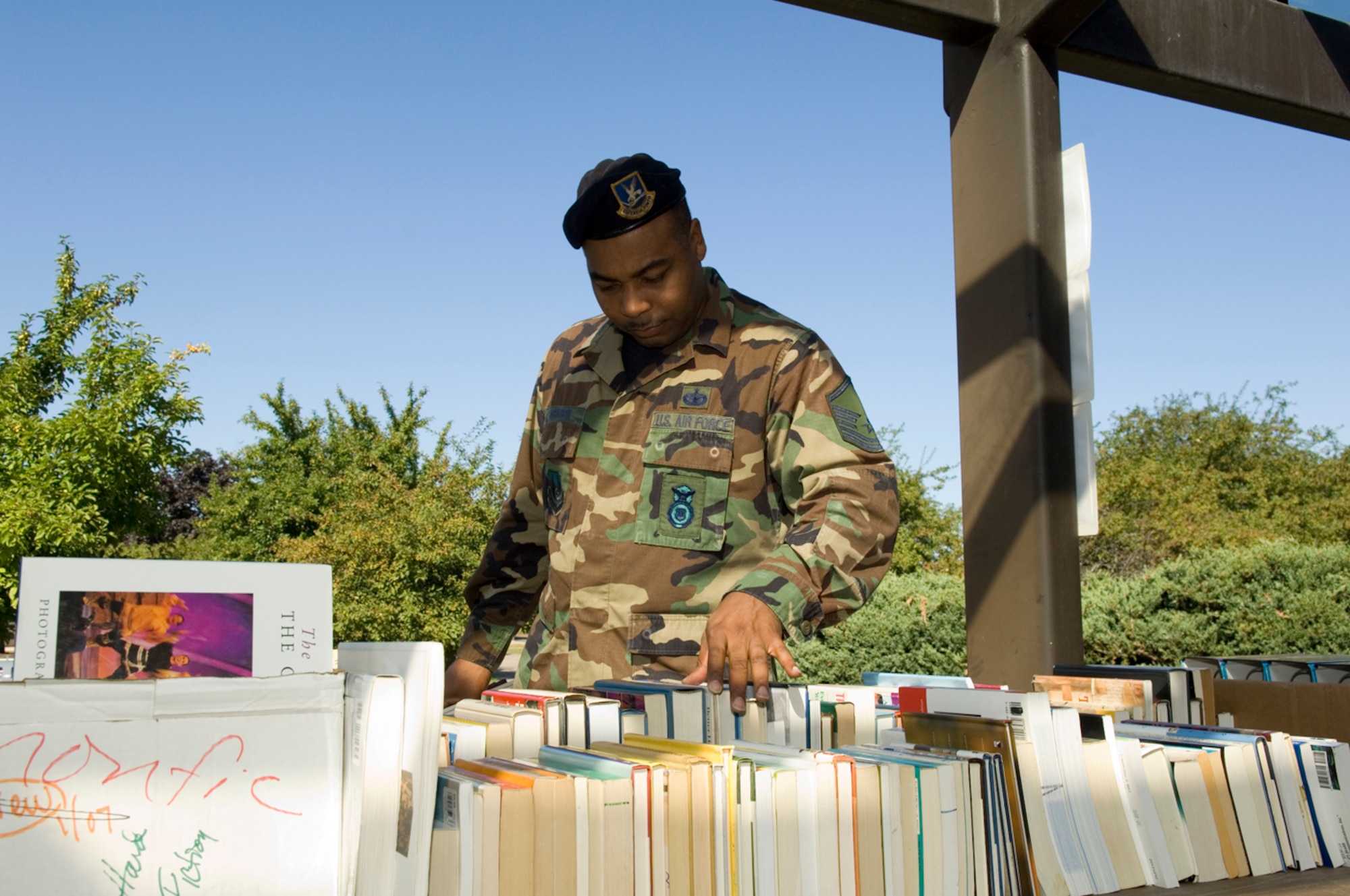 HANSCOM AFB, Mass. -- Senior Master Sgt. Andrew Johnson, 66th Security Forces Squadron, peruses the nonfiction books being sold at the Hanscom Library's used book sale Sept. 11. The library offers patrons a number of adult and children's best sellers and reference books. To check the library's online catalogue, visit www.hanscomservices.com. (U.S. Air Force photo by Rick Berry)
