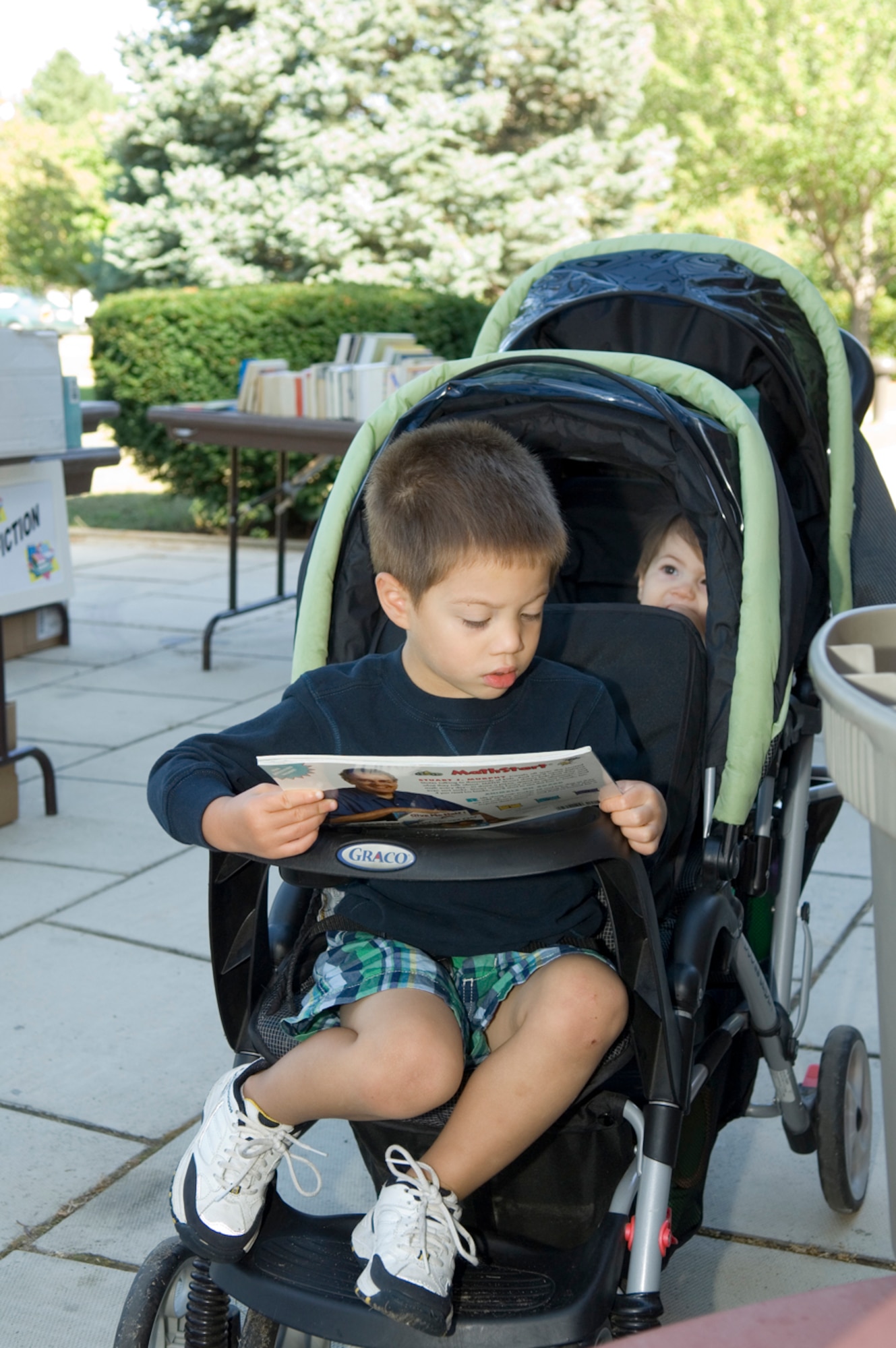 HANSCOM AFB, Mass. -- Benjamin Miller looks at a children's math book during a used book sale held on the patio outside the Hanscom Library Sept. 11. In addition to all genres of books, the Library has a number of reduced admission passes to area museums and attractions available to base families. For more information, visit www.hanscomservices.com. (U.S. Air Force photo by Rick Berry)