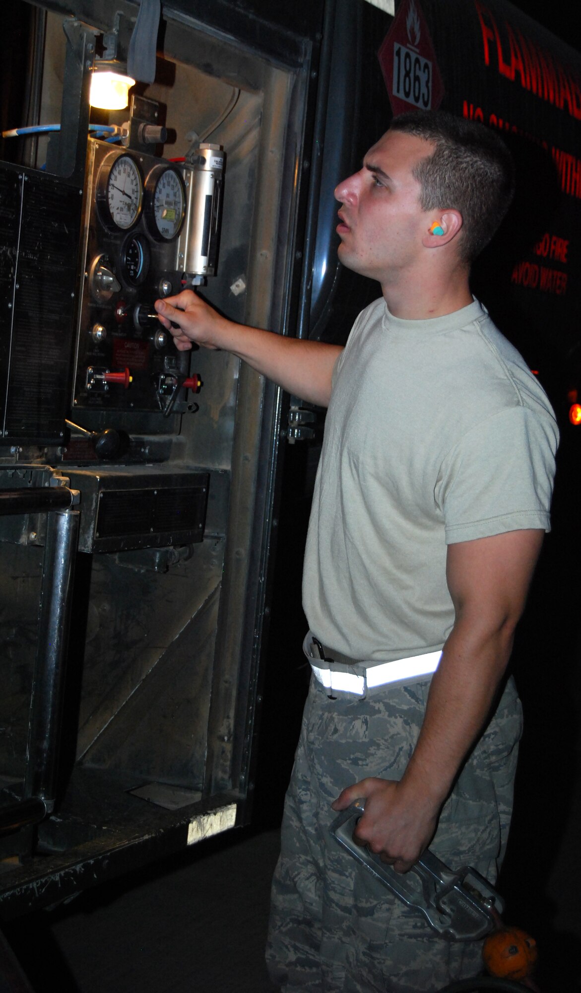 JOINT BASE BALAD, Iraq -- Senior Airman Mark Matzye checks fuel gauges on a refueling truck at the hot cargo pad here Sept. 9. Matzye was refueling a Marine Corps AV-8B Harrier that landed here due to inclement weather over al-Asad Air Base in Anbar Province. Matzye is deployed to the 332nd Expeditionary Logistics Readiness Squadron here from Youngstown Air Reserve Station, Ohio. The Harrier is deployed from Marine Attack Squadron 311 at Marine Corps Air Station Yuma, Ariz. (U.S. Air Force photo/Staff Sgt. Don Branum)