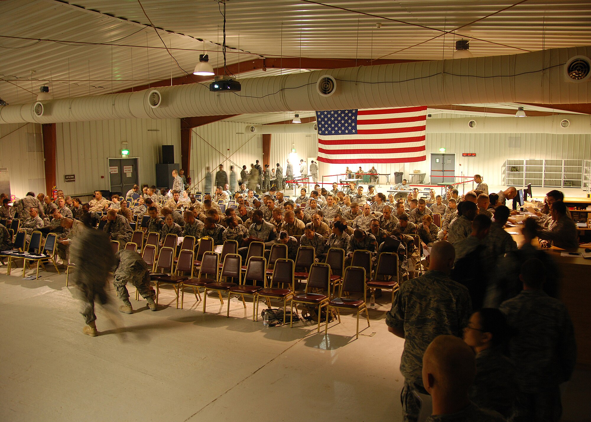 SOUTHWEST ASIA -- Members of the 386th Air Expeditionary Wing preparing to travel back to their home stations after completing deployments in the U.S. Central Command area of responsibility wait to proceed through the processing line on Sept. 11 at an air base in Southwest Asia. The 386th Expeditionary Force Support Squadron's Personnel Support for Contingency Operations (PERSCO) section is currently processing hundreds of personnel in and out of the base during an air expeditionary force swap out.  (U.S. Air Force photo/Tech. Sgt. Raheem Moore)