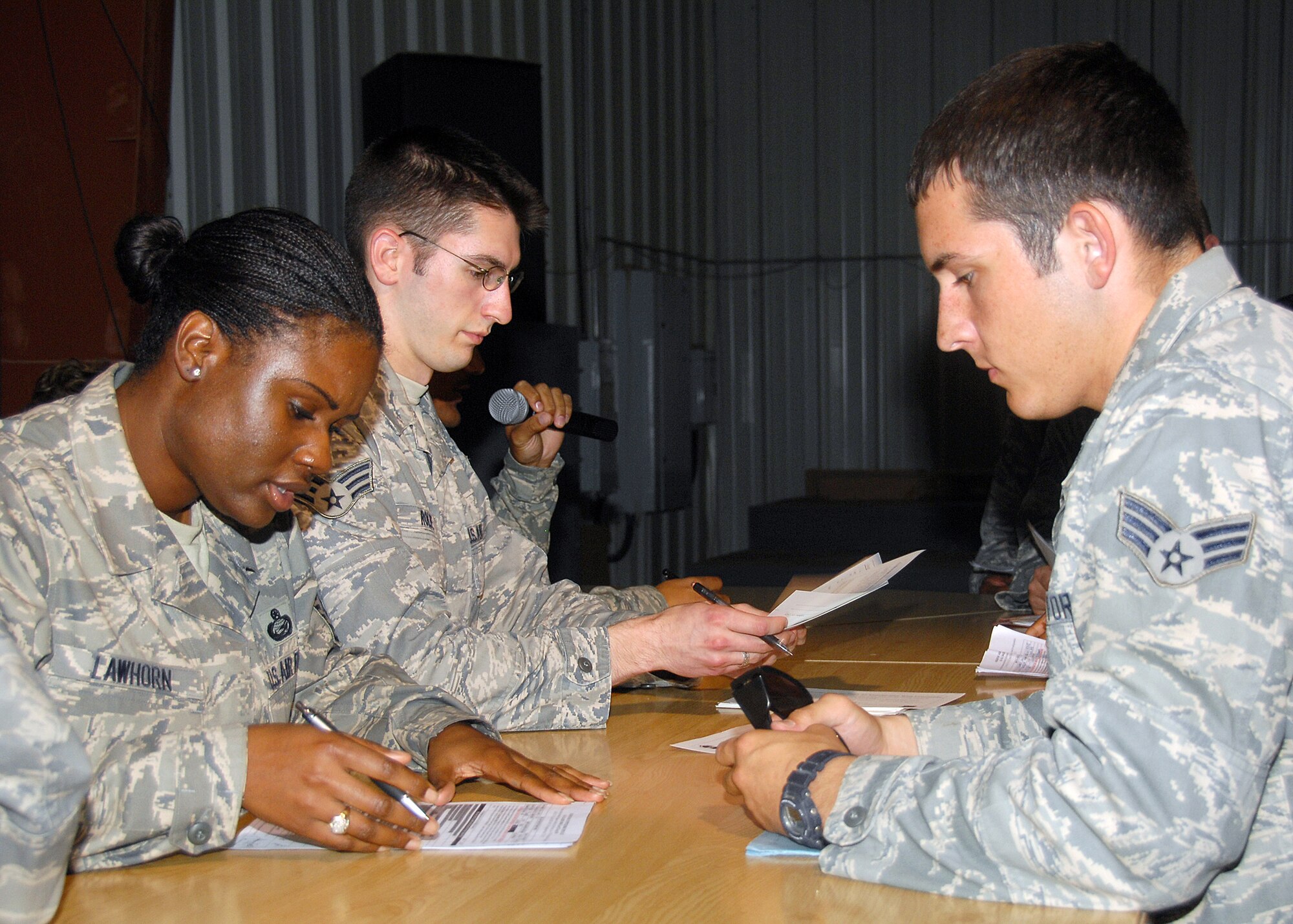 SOUTHWEST ASIA -- Master Sgt. Larissa Lawhorn, 386th Expeditionary Force Support Squadron, looks over the outprocessing paperwork of an Airman on Sept. 11 at an air base in Southwest Asia. The 386th EFSS Personnel Support for Contingency Operations (PERSCO) is currently processing hundreds of personnel in and out of the base during an air expeditionary force swap out. Sergeant Lawhorn is the PERSO NCO-in-charge. She is deployed from Wright-Patterson Air Force Base, Ohio. (U.S. Air Force photo/Tech. Sgt. Raheem Moore)   
 

