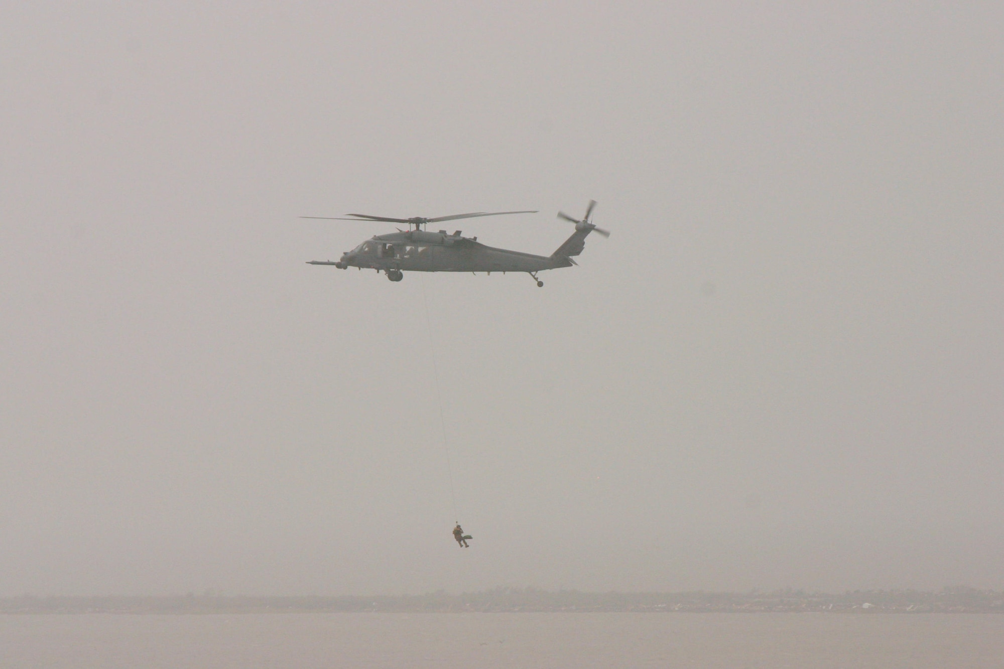 A Joint Task Force-129 pararescueman hoists a hurricane victim in to the hovering HH-60G Pave Hawk helicopter Sept. 13 near Galveston, Texas. The JTF-129 crews rescued 48 people and pets stranded 