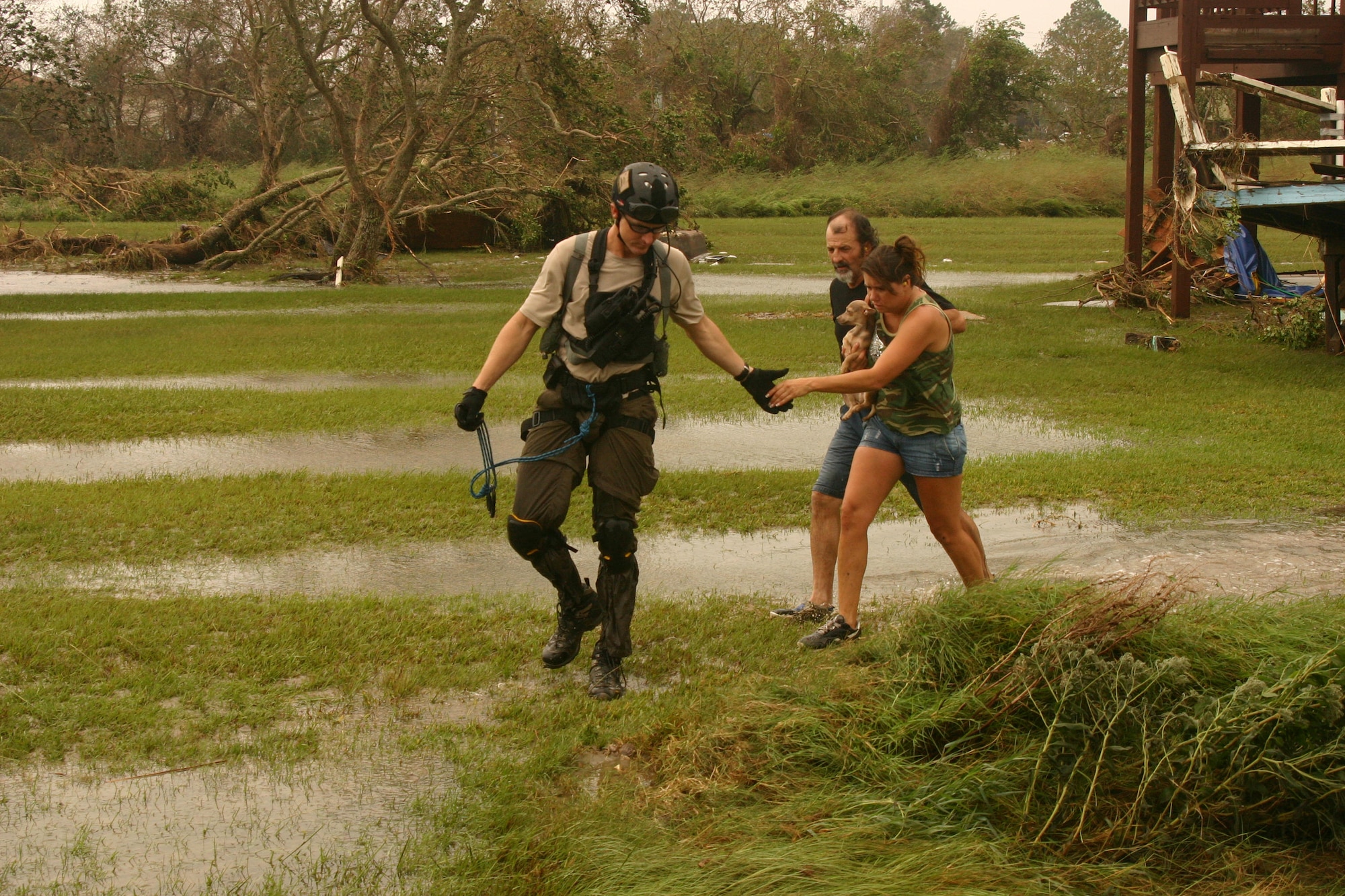 A Joint Task Force-129 pararescueman rescues hurricane victims Sept. 13 in Crystal Beach, Texas. The JTF-129 crews rescued 48 people and pets stranded in the Galveston area. (U.S. Air Force photo/Tech. Sgt. Brock Woodward) 
