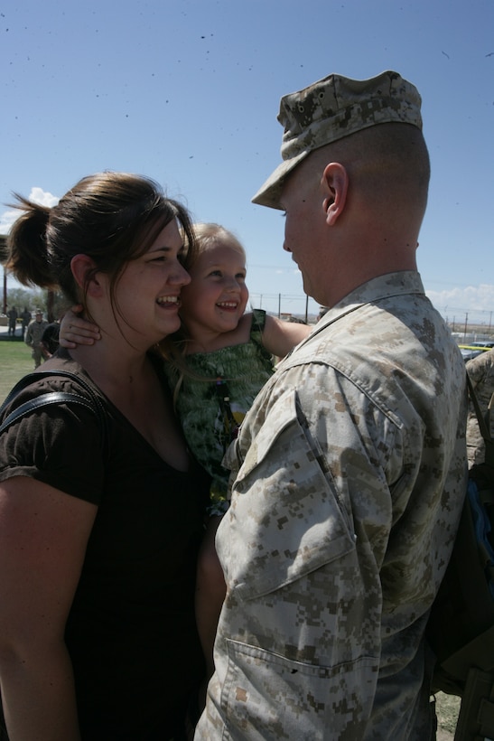 Gunnery Sgt. Damon McElrath, maintenance chief with Marine Wing Support Squadron 374, is greeted by his wife, Kristina, and 3-year-old daughter, Alyssa, during the MWSS-374 and 3rd Battalion, 4th Marine Regiment, homecoming at Victory Field aboard the Marine Corps Air Ground Combat Center Sept. 16, 2008.