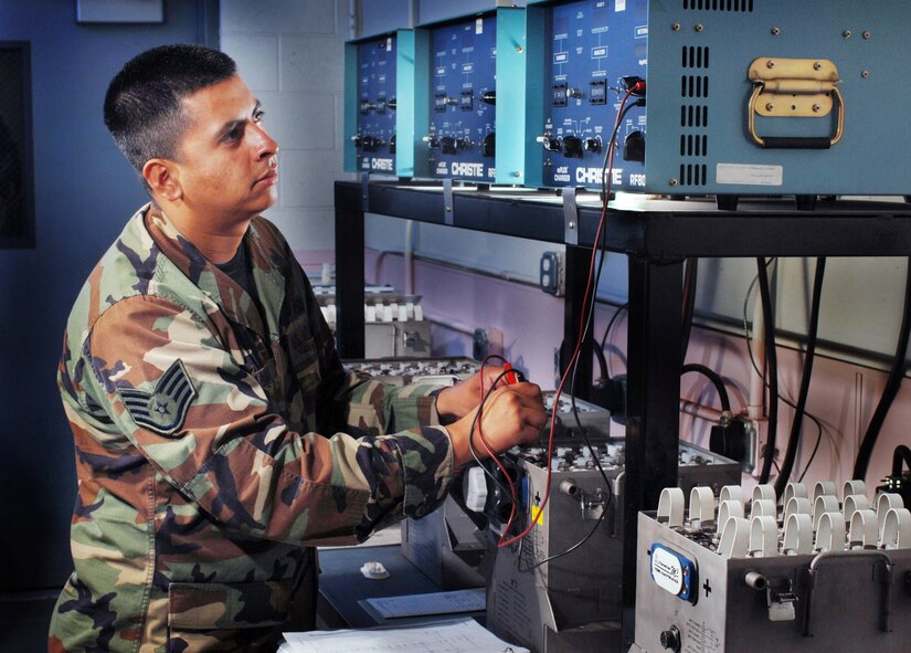 Staff  Sgt. Abraham Lagunas, an aircraft mechanic, uses a multi-meter to check the lead cell voltage on a C-17 Globemaster III aircraft Nicad battery while the it is being recharge by an RF-80 charger at March Air Reserve Base, Calif. He is an Air Reserve Technician from the 452nd Maintenance Squadron. (U.S. Air Force photo by Val Gempis)