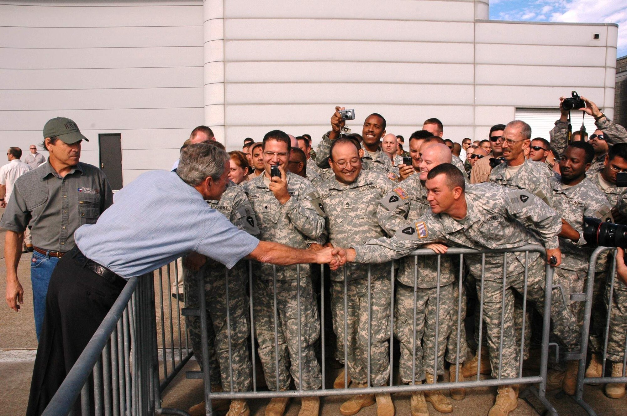 President George W. Bush shakes hands with military members Sept. 16 at Ellington Field, Texas, before assessing the damage from Hurricane Ike from the Marine 1 helicopter around the Gulf Coast. Active duty, Reserve and Guard servicemembers are assisting with the relief effort after the storm ravaged the region. (U.S. Air Force photo/Senior Master Sgt. Marcus Falleaf) 
