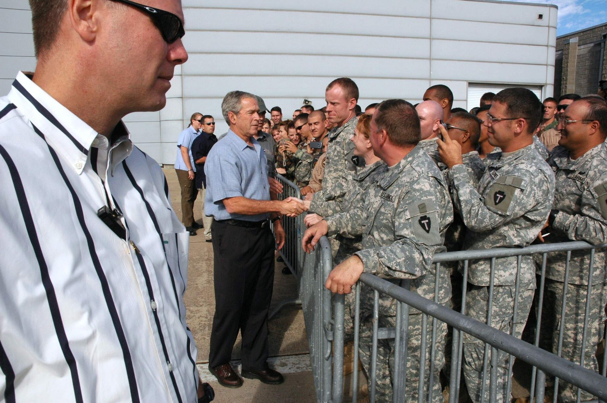 President George W. Bush shakes hands with military members Sept. 16 at Ellington Field, Texas, before assessing the damage from Hurricane Ike from the Marine 1 helicopter around the Gulf Coast. Active duty, Reserve and Guard servicemembers are assisting with the relief effort after the storm ravaged the region. (U.S. Air Force photo/Senior Master Sgt. Marcus Falleaf) 
