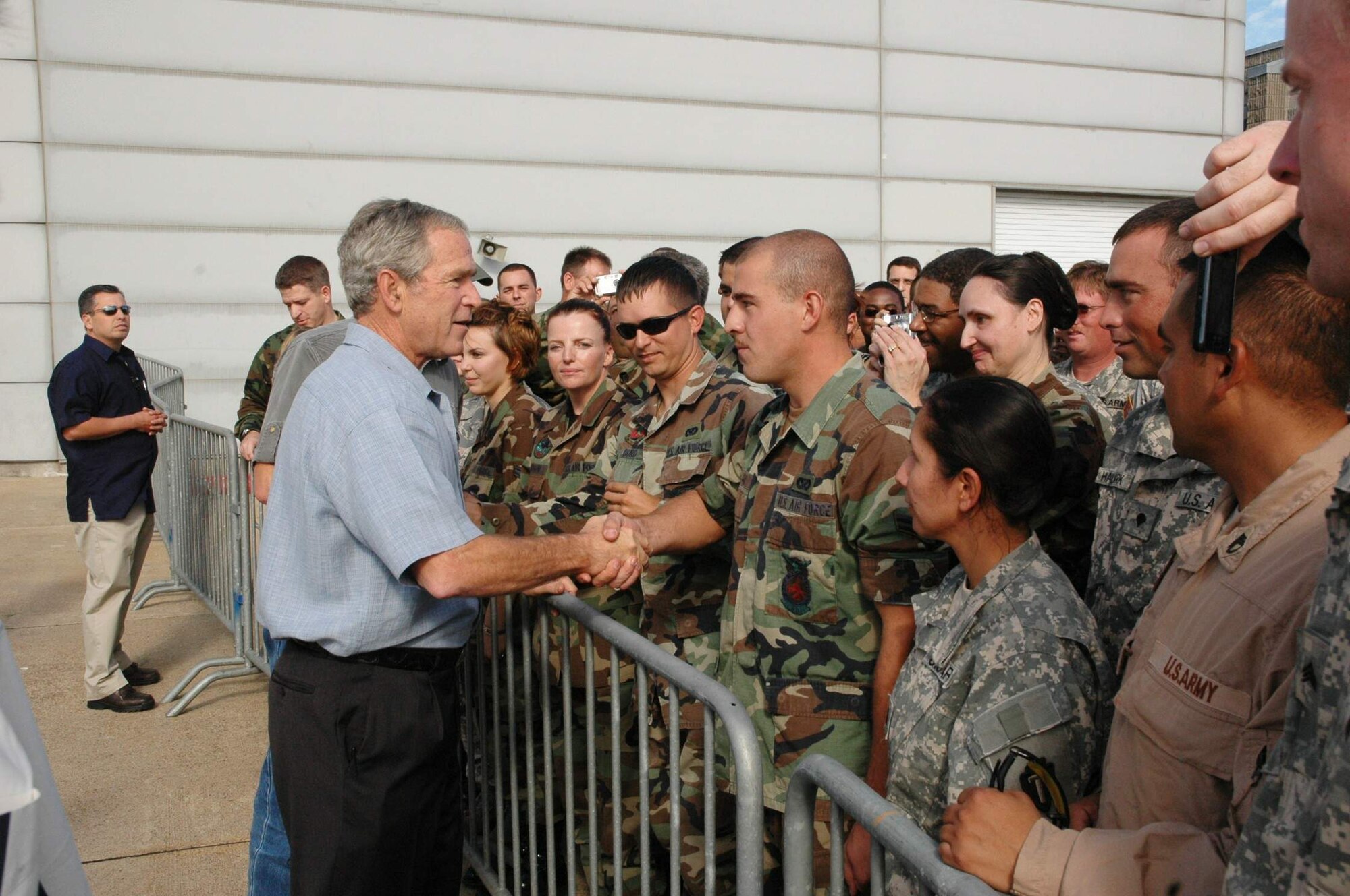 President George W. Bush shakes hands with military members Sept. 16 at Ellington Field, Texas, before assessing the damage from Hurricane Ike from the Marine 1 helicopter around the Gulf Coast. Active duty, Reserve and Guard servicemembers are assisting with the relief effort after the storm ravaged the region. (U.S. Air Force photo/Senior Master Sgt. Marcus Falleaf) 

