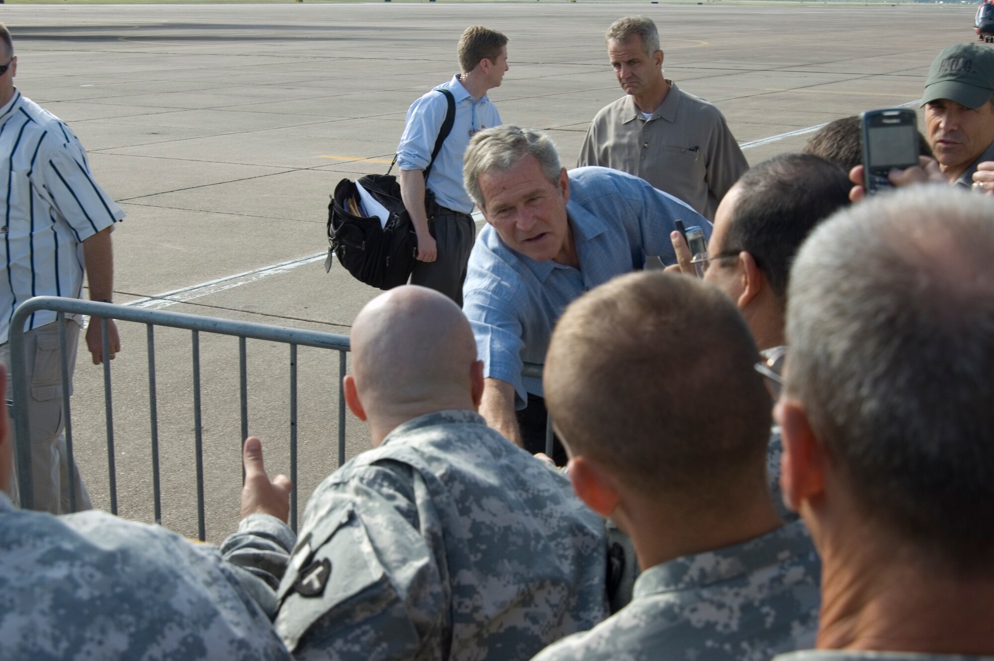President George W. Bush shakes hands with military members Sept. 16 at Ellington Field, Texas, before assessing the damage from Hurricane Ike from the Marine 1 helicopter around the Gulf Coast. Active duty, Reserve and Guard servicemembers are assisting with the relief effort after the storm ravaged the region. (U.S. Air Force photo/Tech. Sgt. Matthew McGovern) 
