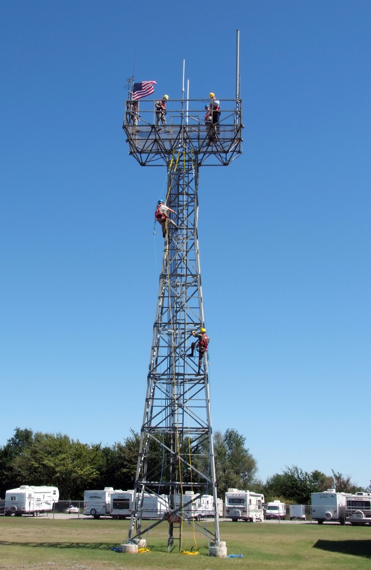 Fellow members of the 71st Communications Squadron scale a 75-foot antenna tower at Vance AFB, Okla., to participate in Senior Airman Virginia Liranzo’s reenlistment ceremony, Sept. 15. She was reenlisted by Lt. Col. David Stewart, 71st Mission Support Group deputy commander, and former commander of the 71st CS. (U.S. Air Force photo by Terry Wasson)