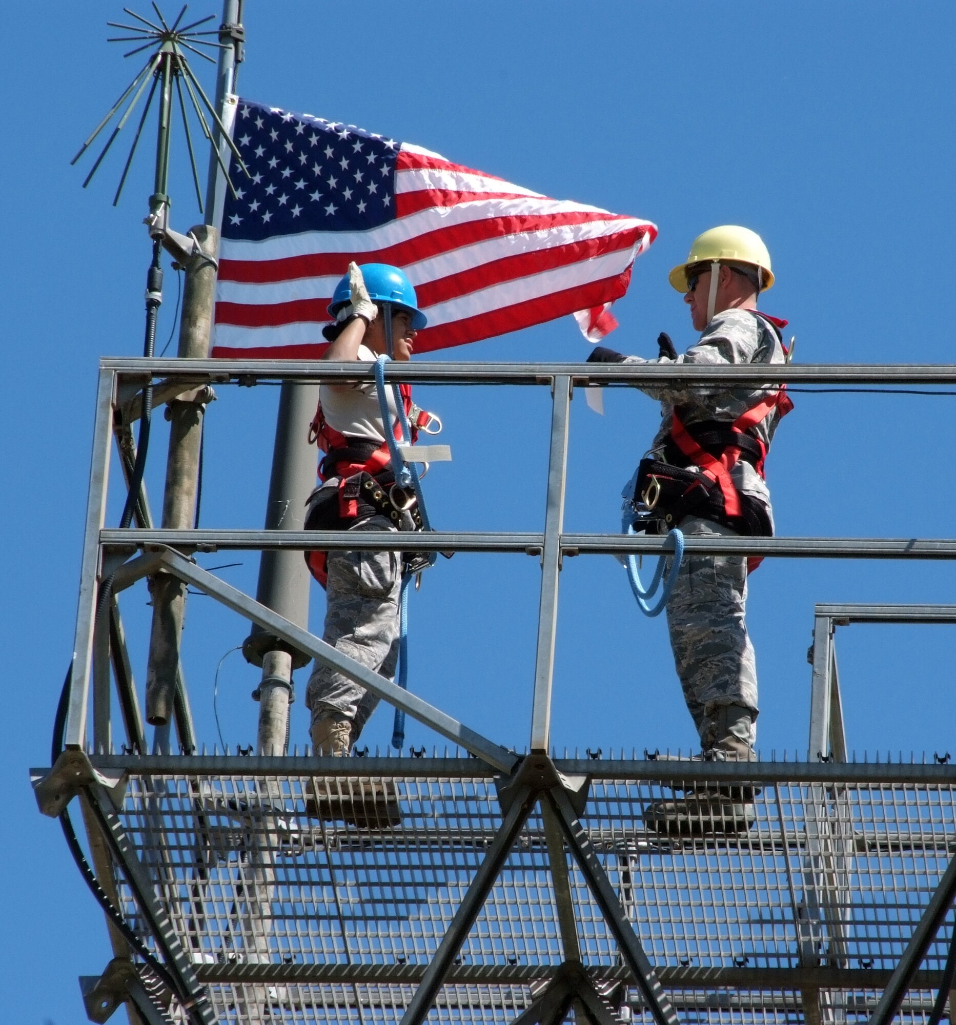Senior Airman Virginia Liranzo, left, with the 71st Communications Squadron, receives her reenlistment oath from Lt. Col. David Stewart, 71st Mission Support Group deputy commander, during a ceremony Sept. 15 at the top of a 75-foot antenna tower at Vance AFB, Okla. Colonel Stewart is a former commander of the Communications Squadron. (U.S. Air Force photo by Terry Wasson)