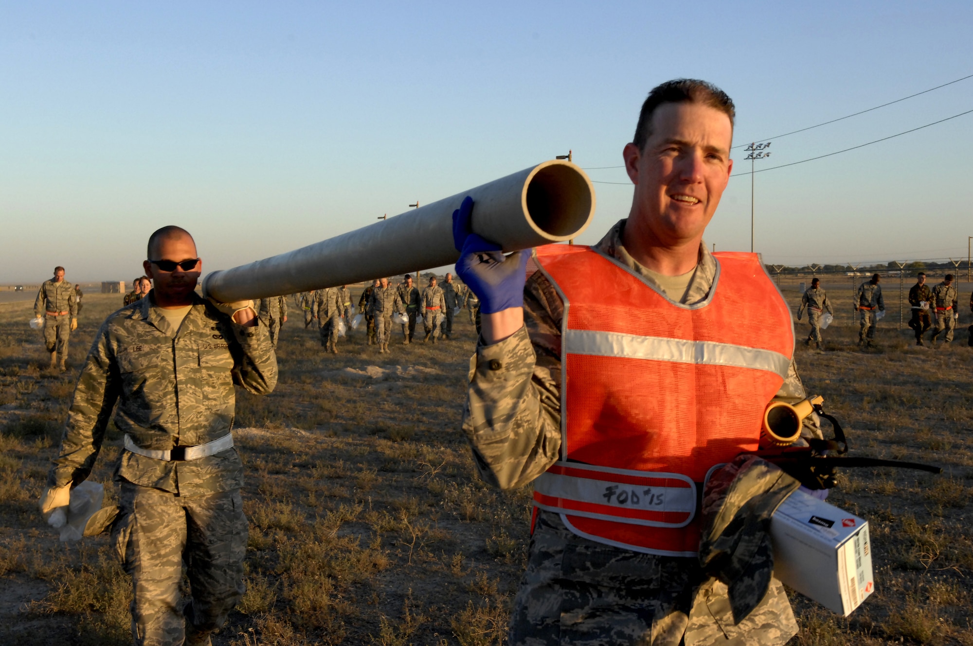MOUNTAIN HOME AIR FORCE BASE, Idaho - (right) Master Sgt. John Deegan, 366th Services Squadron first sergeant, and Senior Airman Robert Lee, 366th Civil Engineer Squadron readiness flight, found an eight-foot piece of foreign object debris on the flightline during the annual FOD walk at Mountain Home Air Force Base Sept. 15. The FOD walk was scheduled to clear the flightline of objects that were left over after the Gunfighter Skies 2008 air show held over the weekend. (U.S. Air Force photo\ Staff Sgt. Brian Stives)